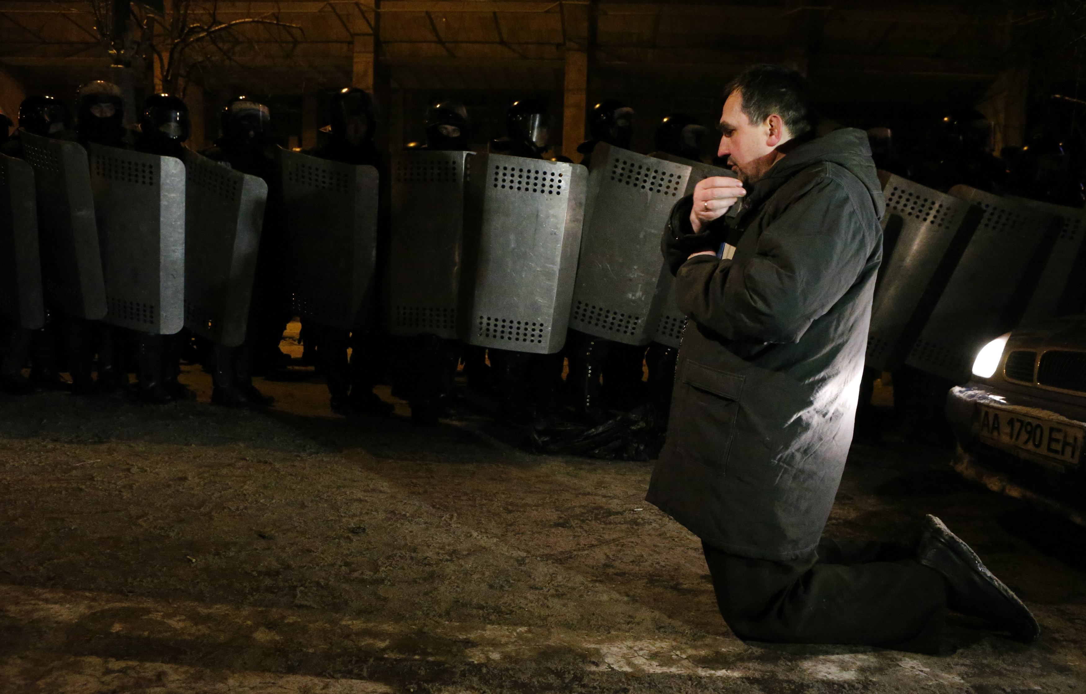 Κίεβο: Η προσευχή του διαδηλωτή μπροστά στα ΜΑΤ – Άγρια επεισόδια