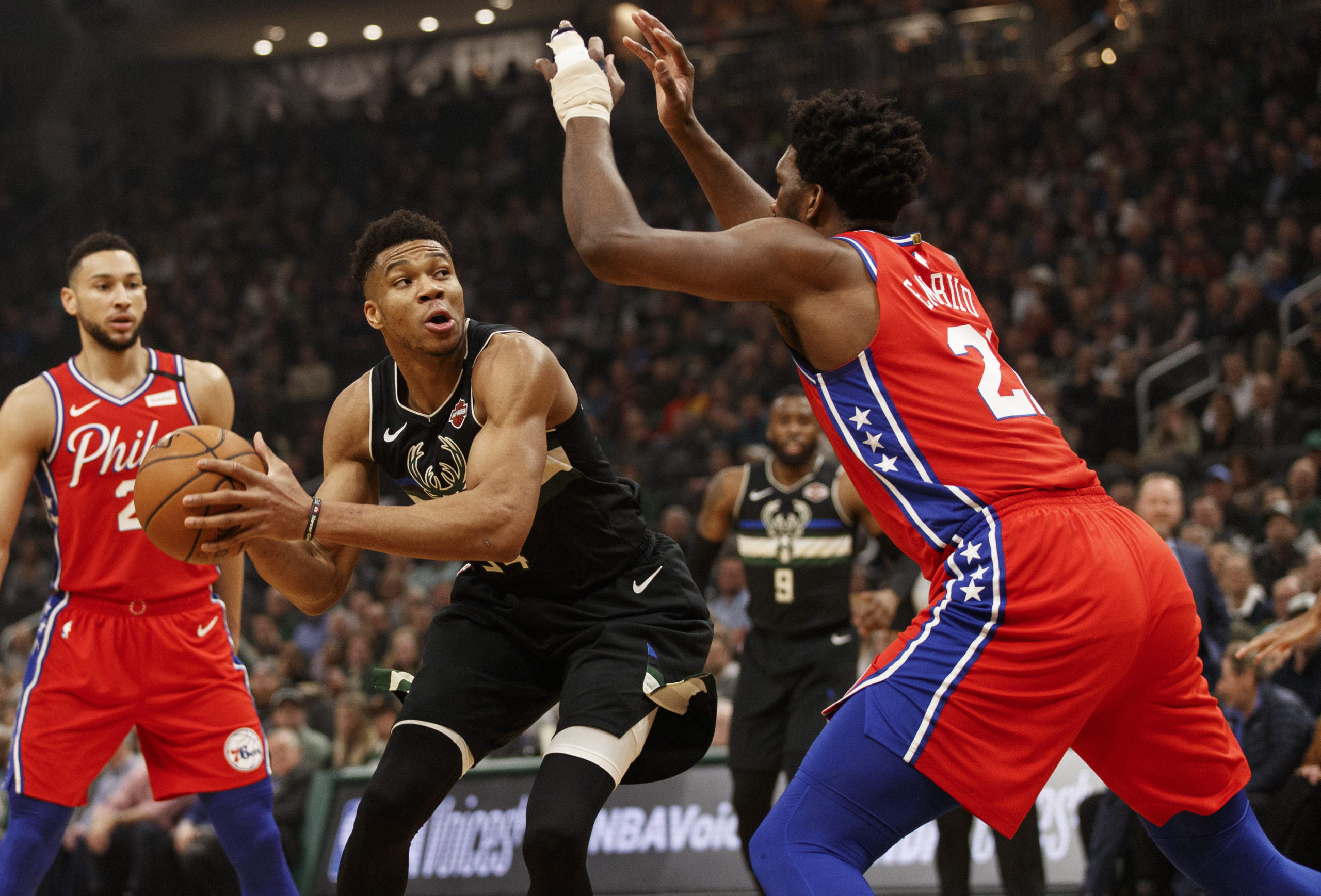 Feb 6, 2020; Milwaukee, Wisconsin, USA;  Milwaukee Bucks forward Giannis Antetokounmpo (34) drives against Philadelphia 76ers center Joel Embiid (21) during the first quarter at Fiserv Forum. Mandatory Credit: Jeff Hanisch-USA TODAY Sports