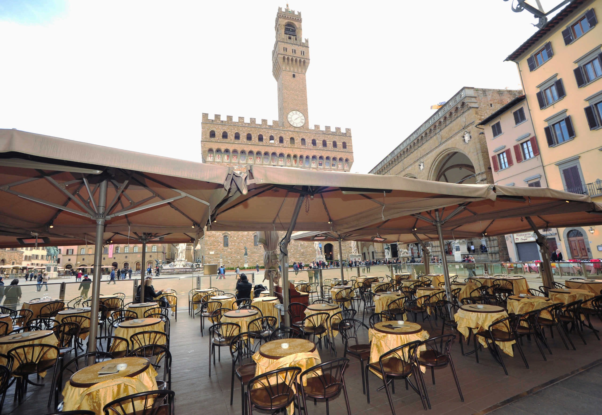 Empty tables are pictured outside a restaurant at Palazzo Vecchio as Italy battles a coronavirus outbreak, in Florence, Italy, March 7, 2020. REUTERS