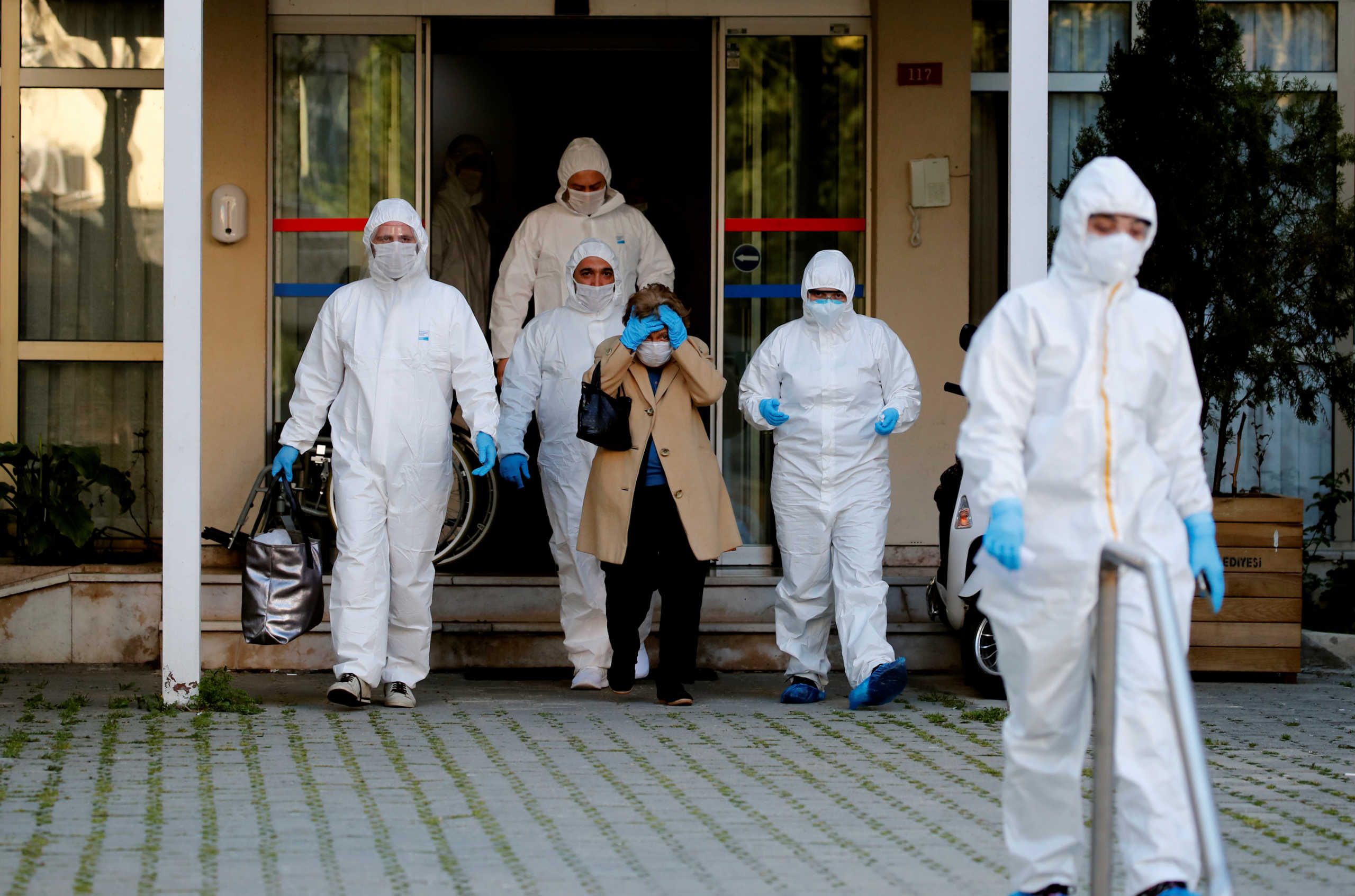 Paramedics escort a woman as she walks toward an ambulance during a two-day curfew which was imposed to prevent the spread of the coronavirus disease (COVID-19), in Istanbul, Turkey, April 12, 2020. REUTERS