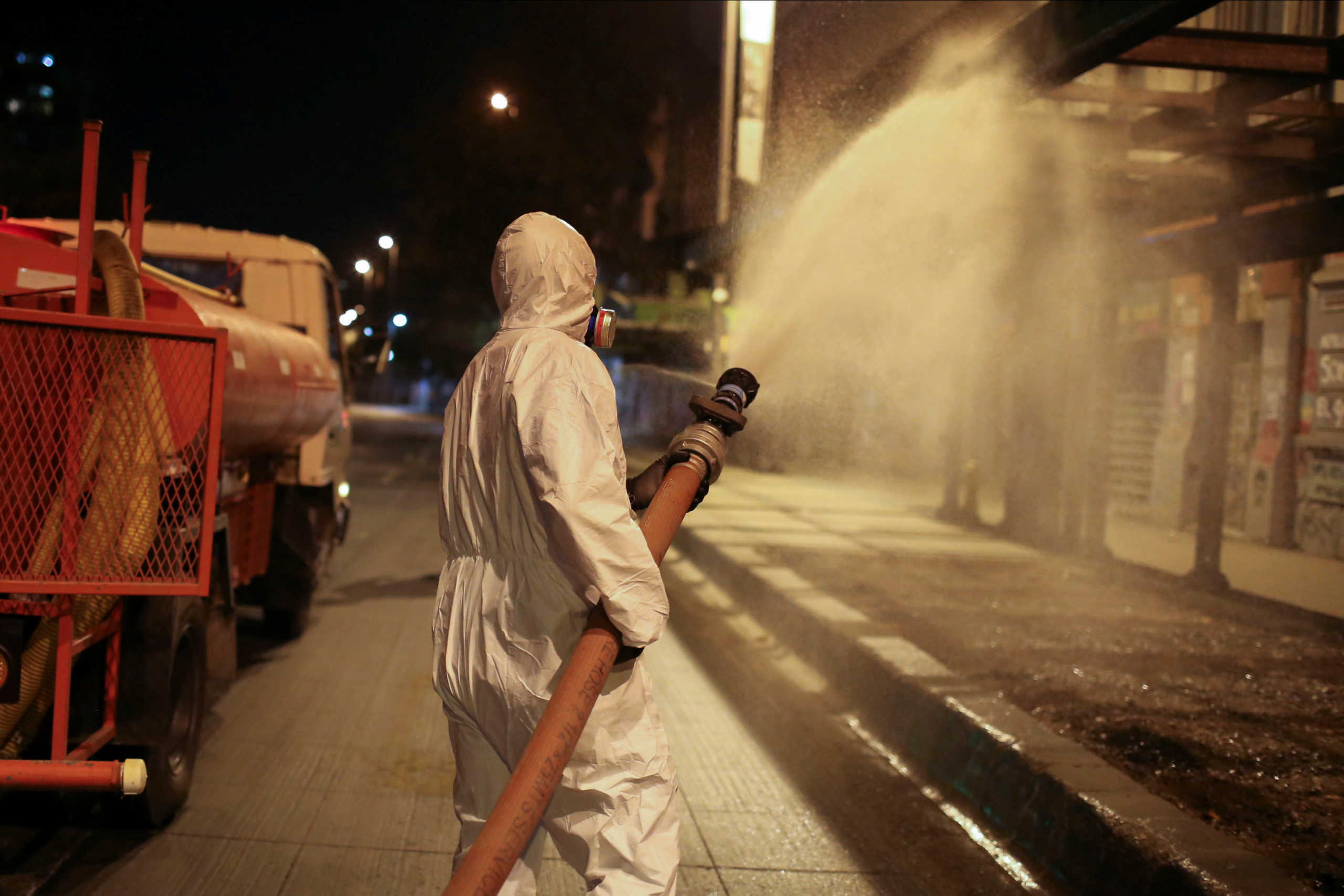 Local workers clean the streets as a precautionary measure, amid the coronavirus disease (COVID-19) outbreak, in Santiago, Chile  April 1, 2020. REUTERS