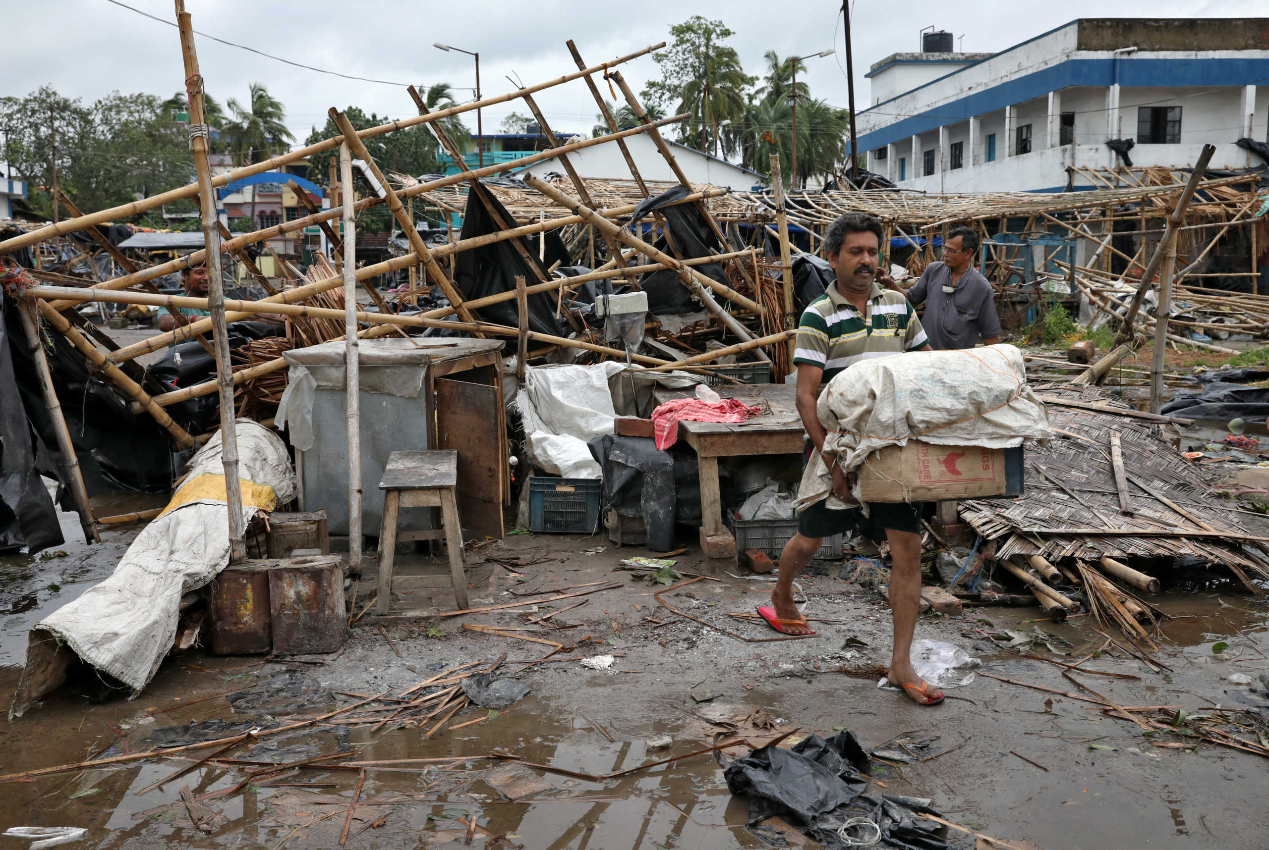 A man salvages his belongings from the rubble of a damaged shop after Cyclone Amphan made its landfall, in South 24 Parganas district in the eastern state of West Bengal, India, May 21, 2020. REUTERS