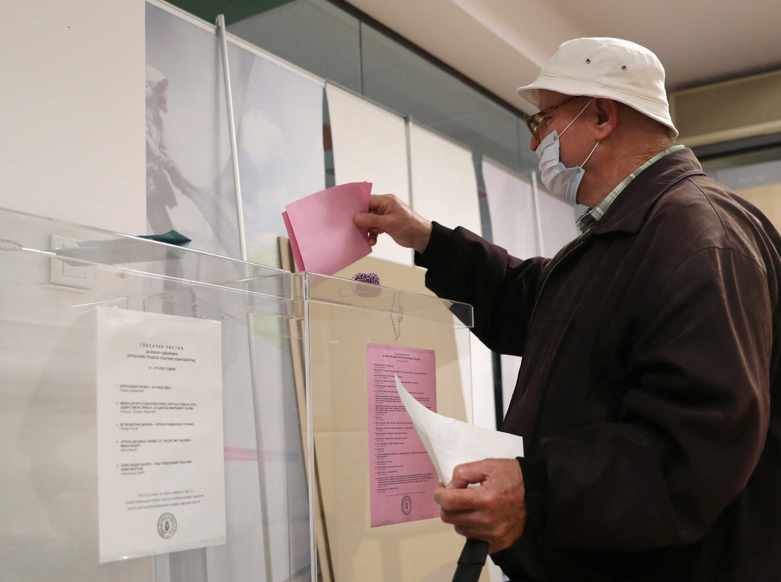 Voter wearing a face mask casts his ballot in the country's general election at a polling station in Belgrade, Serbia June 21, 2020. REUTERS