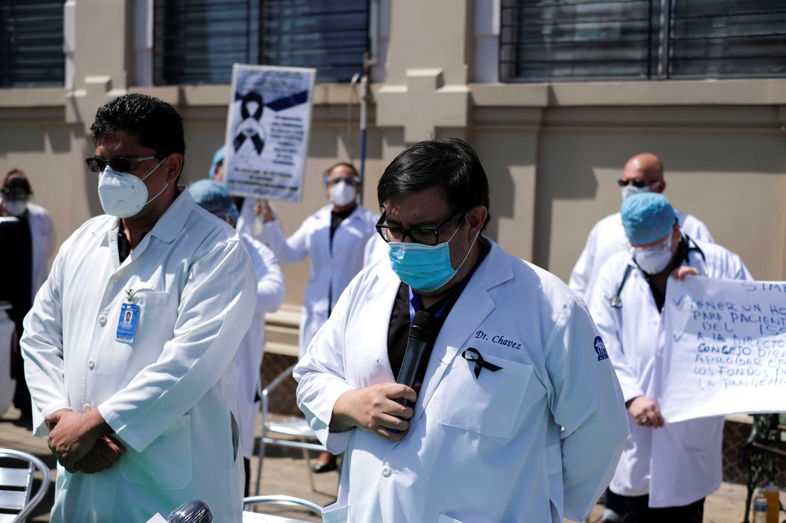 Doctors and health personnel of the Salvadoran Social Security Institute (ISSS) keep a minute of silence during a protest outside a hospital to ask for personal protective equipment (PPE) and better work conditions, on National Doctors' Day, as the coronavirus disease (COVID-19) outbreak continues, in San Salvador, El Salvador July 14, 2020. REUTERS