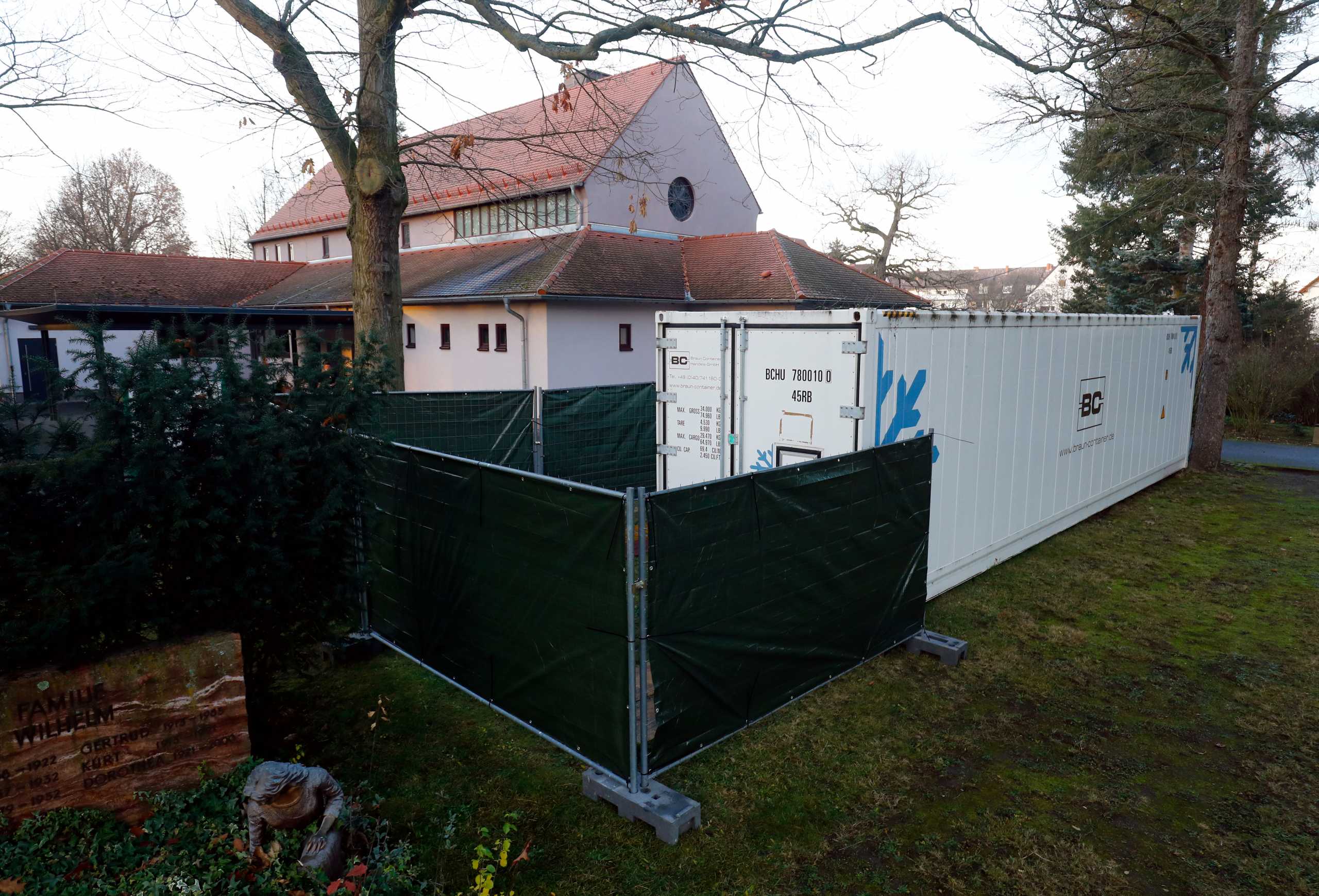 A freezer container, which was set up in April in front of the main cemetery crematorium, is pictured after the numbers of COVID-19 related deaths raised, amid the coronavirus disease (COVID-19) pandemic in Hanau, Germany, December 17, 2020.  REUTERS