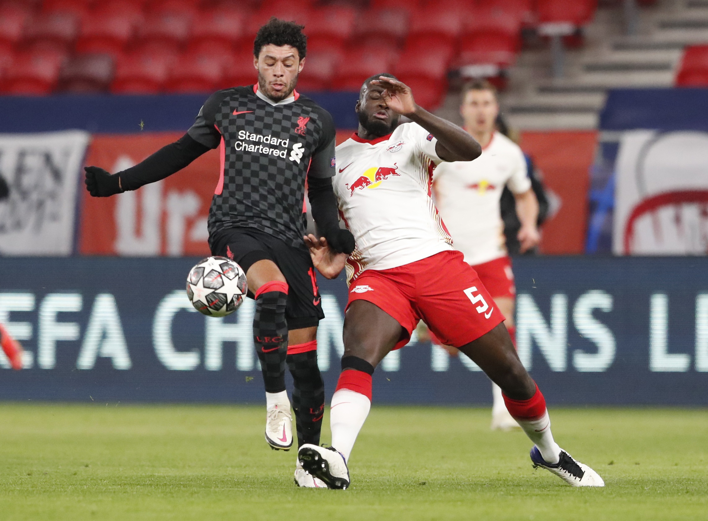 Soccer Football - Champions League - Round of 16 First Leg - RB Leipzig v Liverpool - Puskas Arena, Budapest, Hungary - February 16, 2021 Liverpool's Alex Oxlade-Chamberlain in action with RB Leipzig's Dayot Upamecano REUTERS