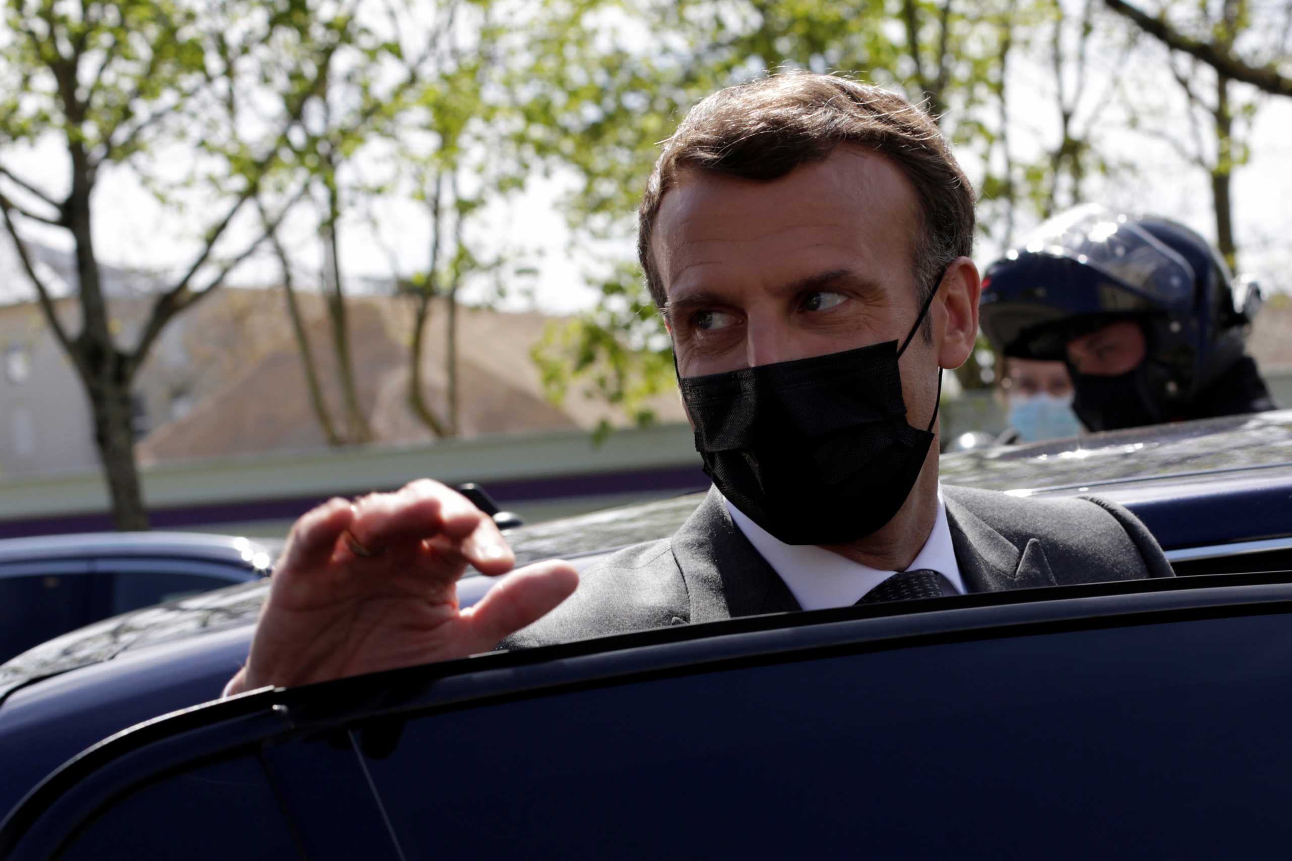 French President Emmanuel Macron enters his car after a visit in a school in Melun, France April 26, 2021. Nursery and primary schools reopened on Monday across France after a three-week closure in the first step out of the country's partial lockdown. Meanwhile, high schools students are following online classes. Thibault Camus