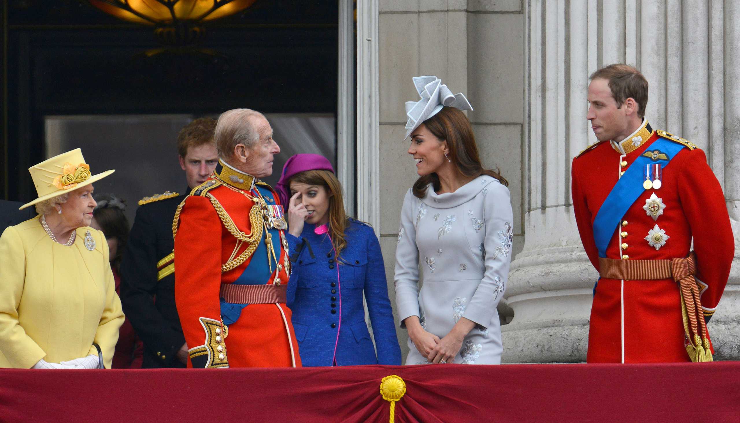 FILE PHOTO: Britain's Queen Elizabeth (L) looks on as her husband Prince Philip, The Duke of Edinburgh, (4R) speaks with Prince William (R) and Catherine, Duchess of Cambridge (2nd R) with Prince Harry (5th R) and Princess Beatrice (3rd R) on the balcony of Buckingham Palace following the Trooping the Colour ceremony in central London June 16, 2012.   REUTERS