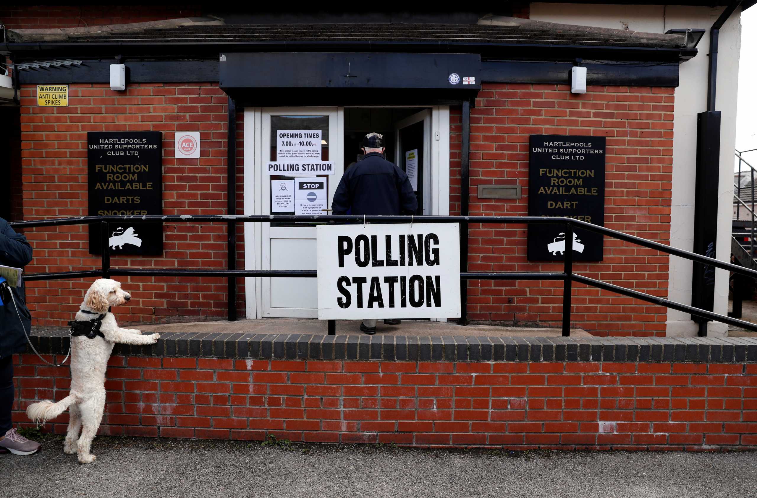 A dog is seen outside a polling station during local elections, in Hartlepool, Britain May 6, 2021. REUTERS