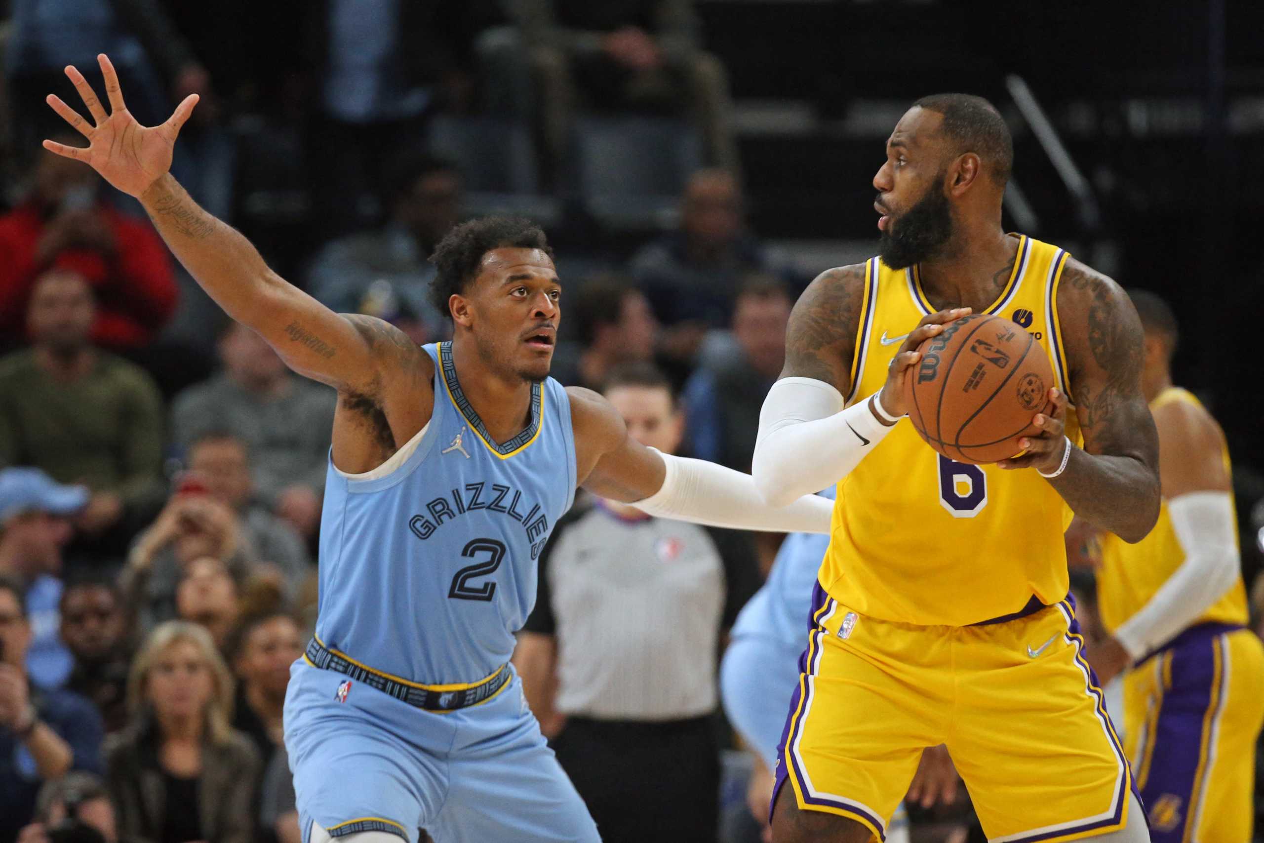 Dec 9, 2021; Memphis, Tennessee, USA; Los Angeles Lakers forward LeBron James (6) controls the ball as Memphis Grizzles forward Xavier Tillman Sr. (2) defends during the second half at FedExForum. Mandatory Credit: Petre Thomas-USA TODAY Sports