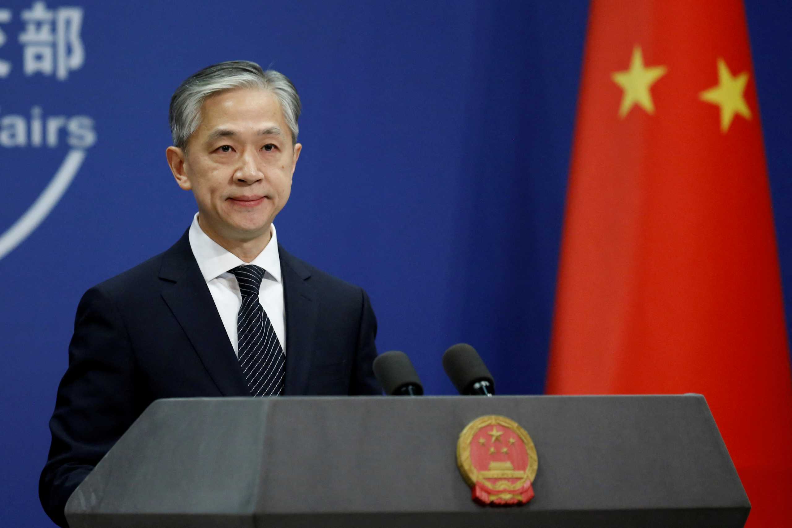 FILE PHOTO: Chinese Foreign Ministry spokesman Wang Wenbin attends a news conference in Beijing, China November 9, 2020. REUTERS