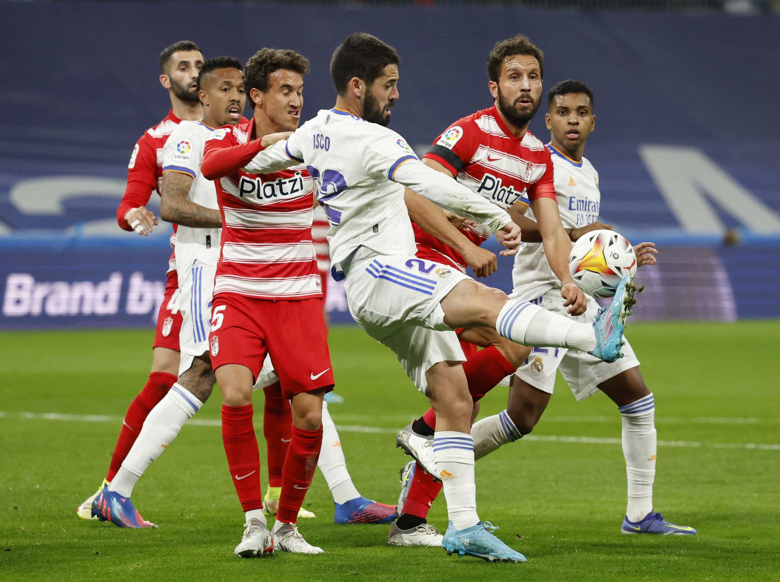 Soccer Football - LaLiga - Real Madrid v Granada - Santiago Bernabeu, Madrid, Spain - February 6, 2022 Real Madrid's Isco in action with Granada's Luis Milla REUTERS