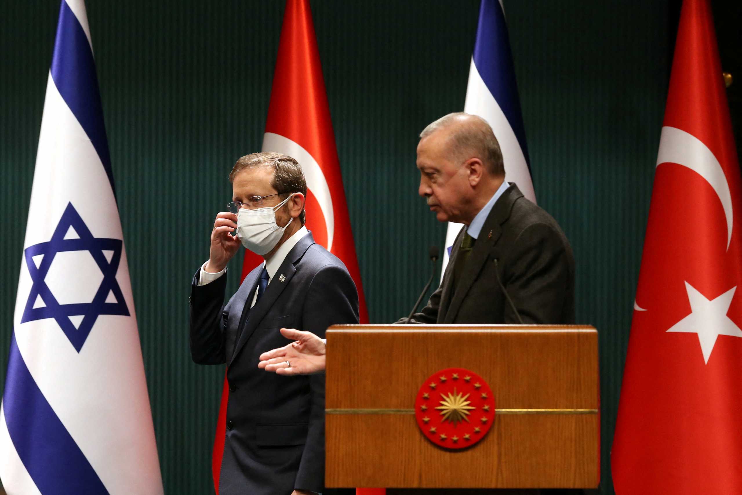 Turkish President Tayyip Erdogan and his Israeli counterpart Isaac Herzog arrive at a joint news conference in Ankara, Turkey March 9, 2022. REUTERS