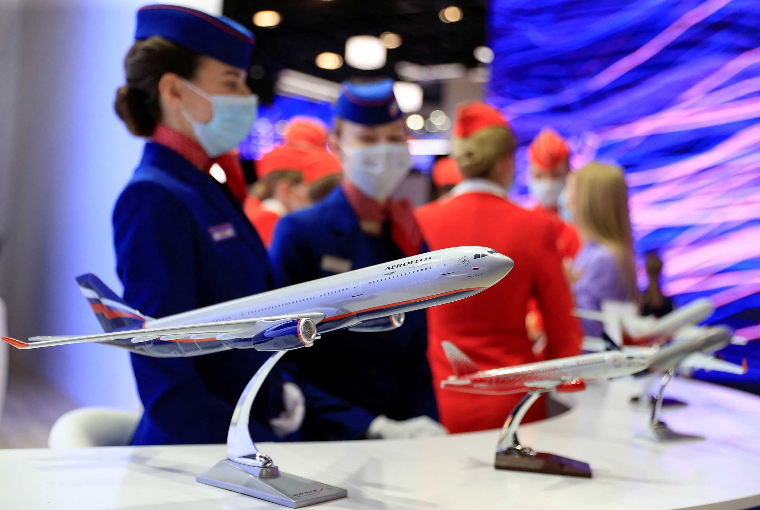 FILE PHOTO: Participants wearing protective face masks gather at the stand of Aeroflot Group Companies during the St. Petersburg International Economic Forum (SPIEF) in Saint Petersburg, Russia, June 2, 2021. REUTERS