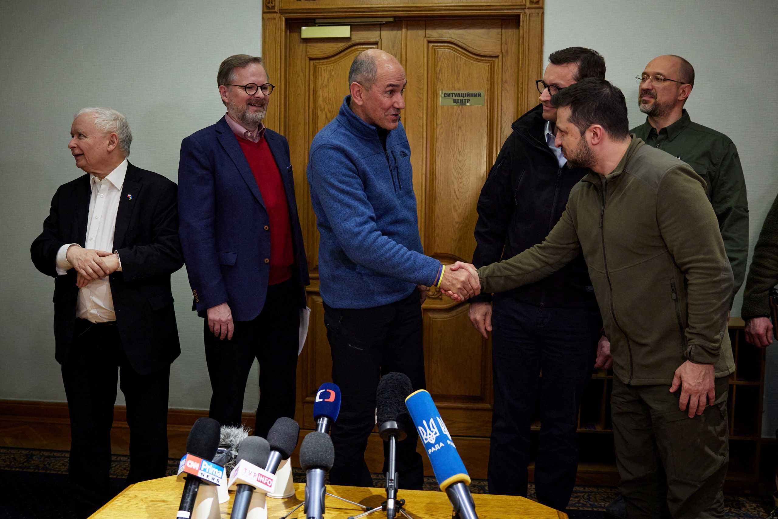 Ukrainian President Volodymyr Zelenskiy shakes hands with Slovenian Prime Minister Janez Jansa during a joint news briefing with Ukrainian Prime Minister Denys Shmygal, Czech Prime Minister Petr Fiala, Polish Prime Minister Mateusz Morawiecki and Deputy Prime Minister Jaroslaw Kaczynski in Kyiv, Ukraine March 15, 2022. Picture taken March 15, 2022.  Ukrainian Presidential Press Service