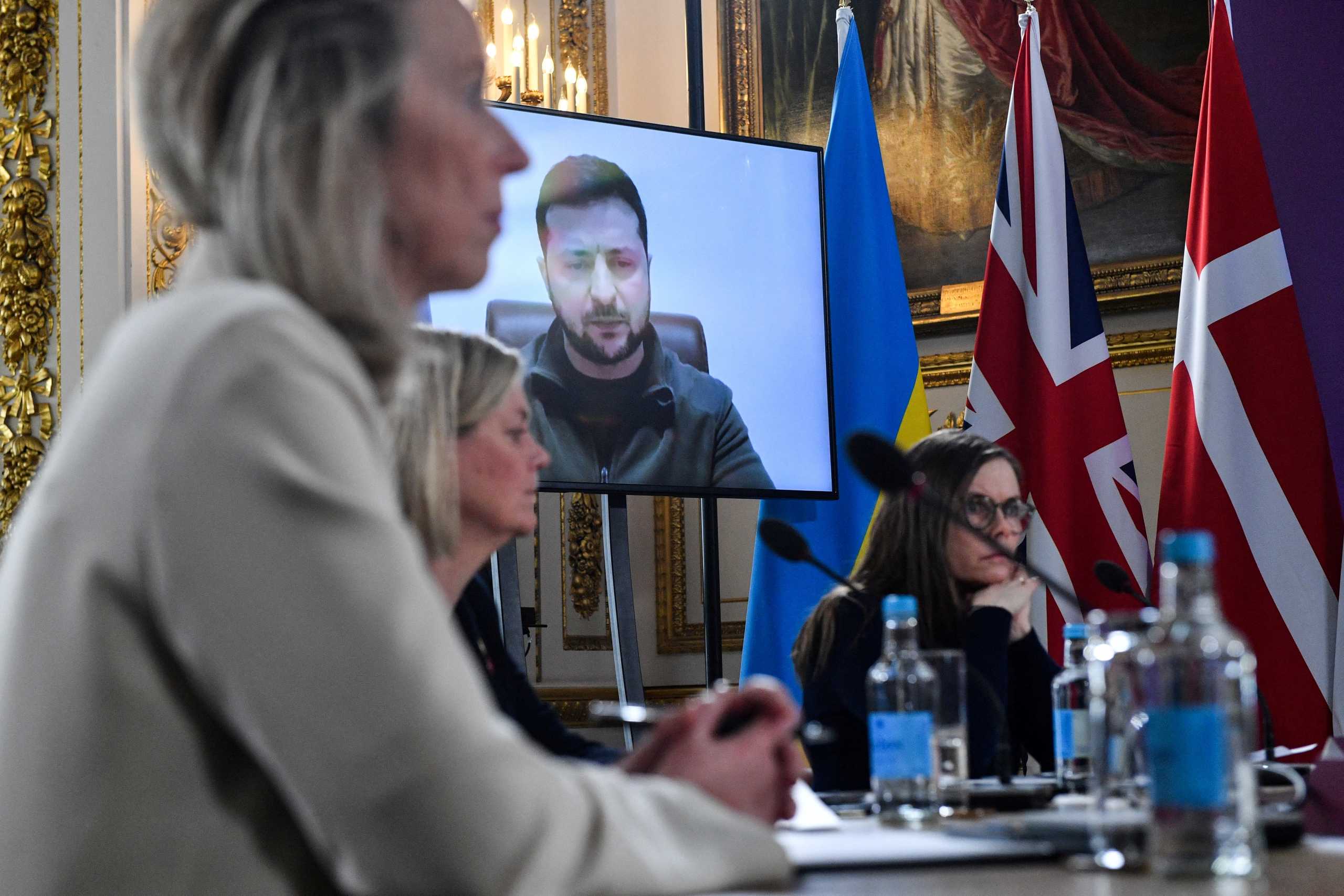 Ukrainian President Volodymyr Zelenskiy addresses, by videolink, attendees of the Joint Expeditionary Force meeting, a coalition of 10 states focused on security in northern Europe, at Lancaster House in London, Britain March 15, 2022. Also pictured are, Netherlands' Defence Minister Kajsa Ollongren, Sweden's Prime Minister Magdalena Andersson and Iceland's Prime Minister Katrin Jakobsdottir. Justin Tallis