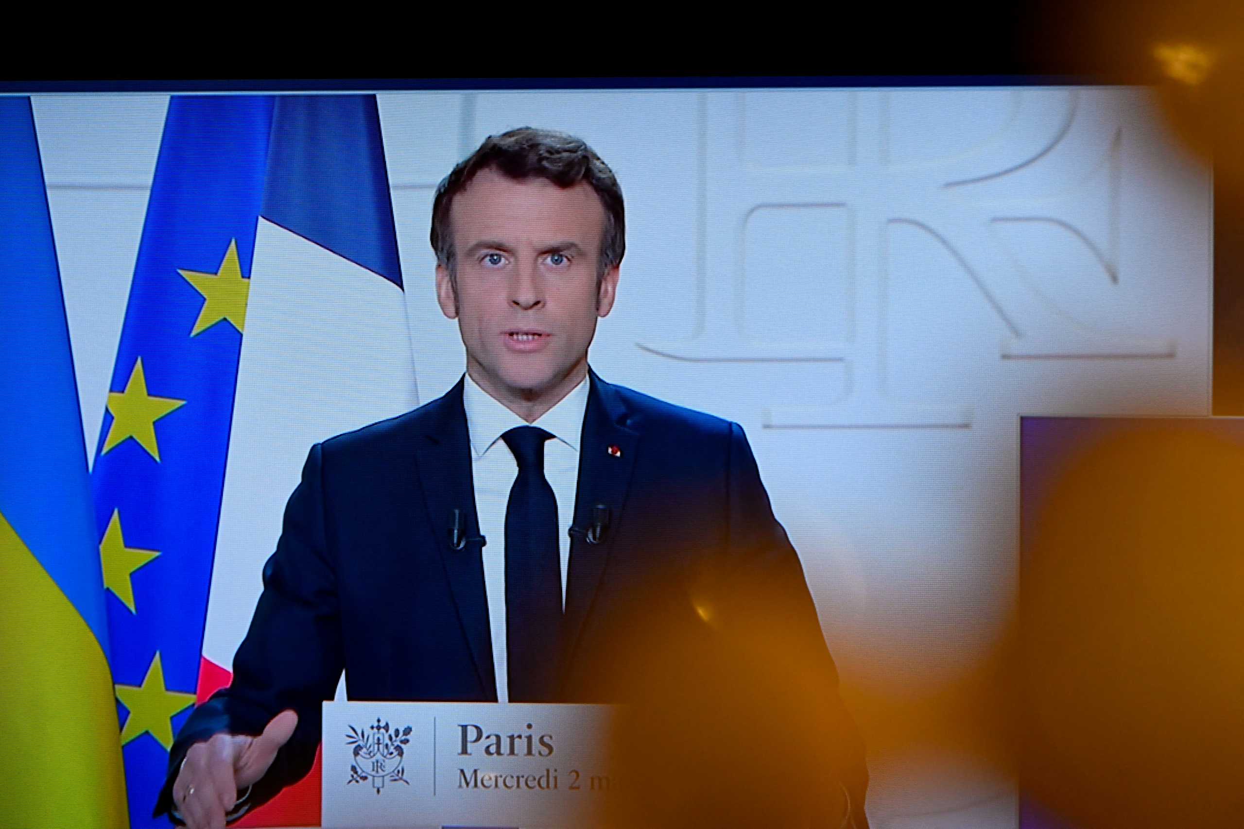 French President Emmanuel Macron appears on a screen as he delivers a speech on the Russian invasion of Ukraine, in Paris, France, March 2, 2022. REUTERS