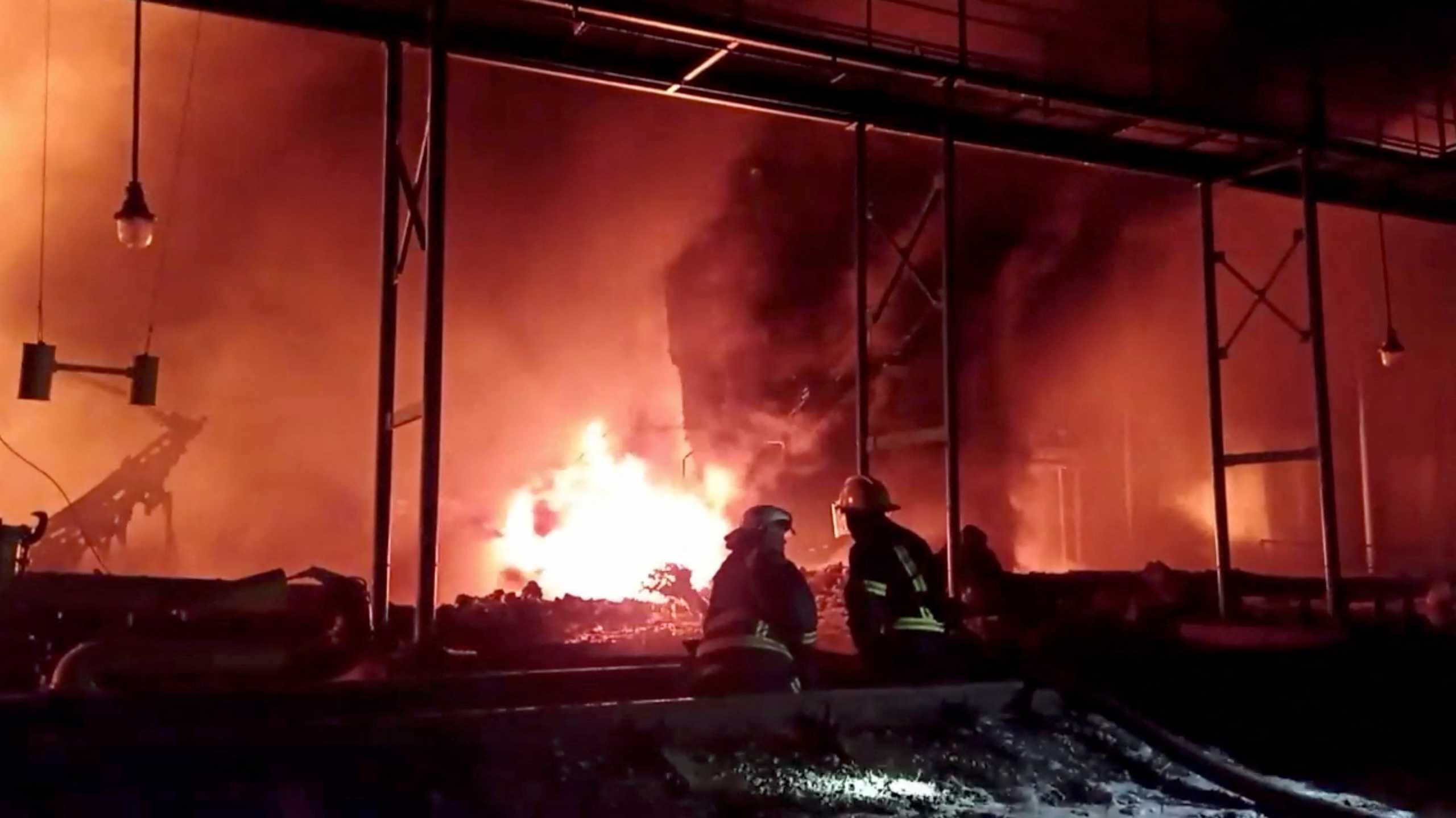 Fire fighters extinguish fire in an oil depot that Ukraine's State Emergency Services say was caused by Russian strikes in Zhytomyr region, Ukraine March 7, 2022 in this still image obtained from a handout video. State Emergency Services of Ukraine