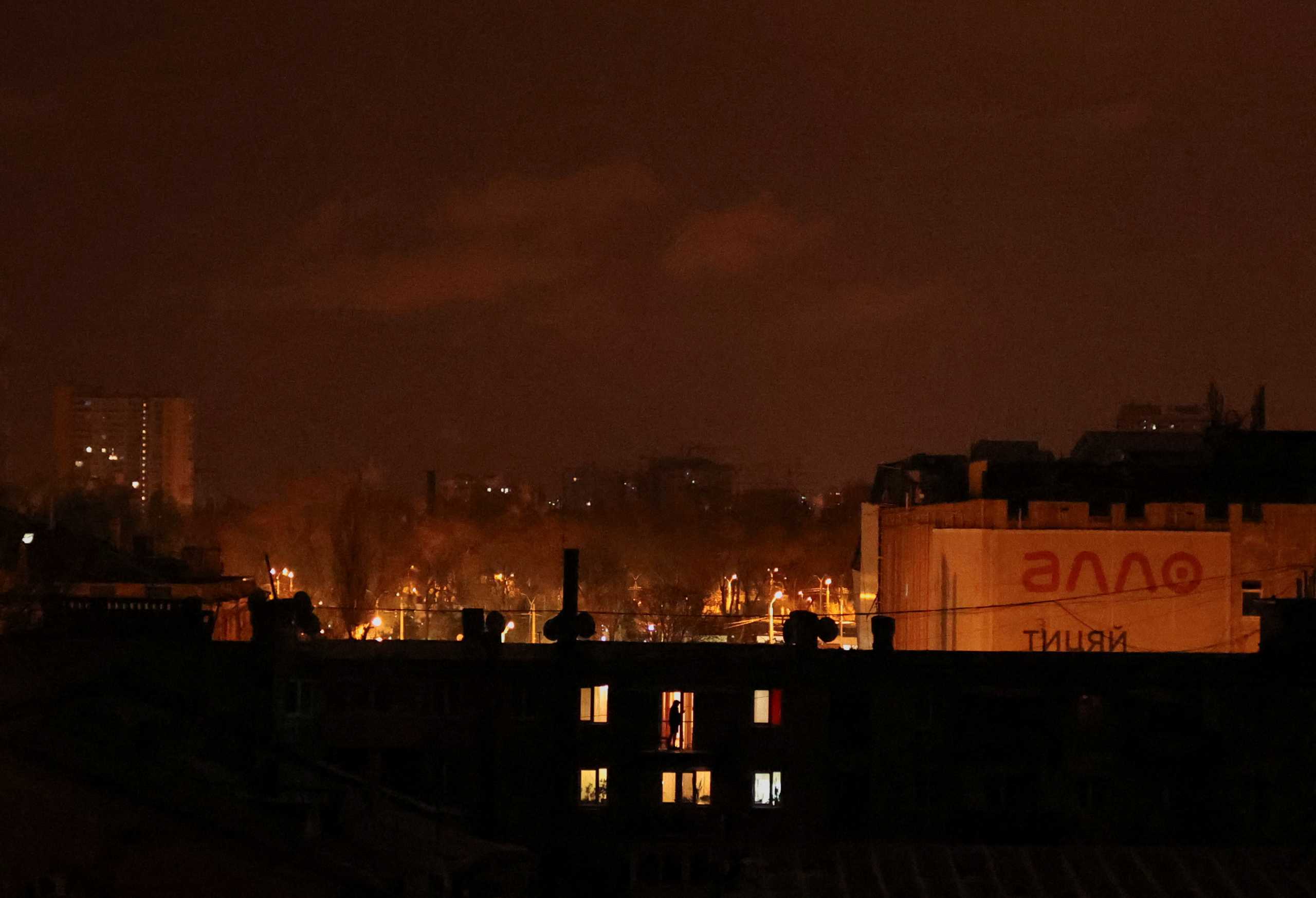 A person stands inside a house after curfew, as Russia's invasion of Ukraine continues, in Odessa, Ukraine, March 11, 2022. REUTERS