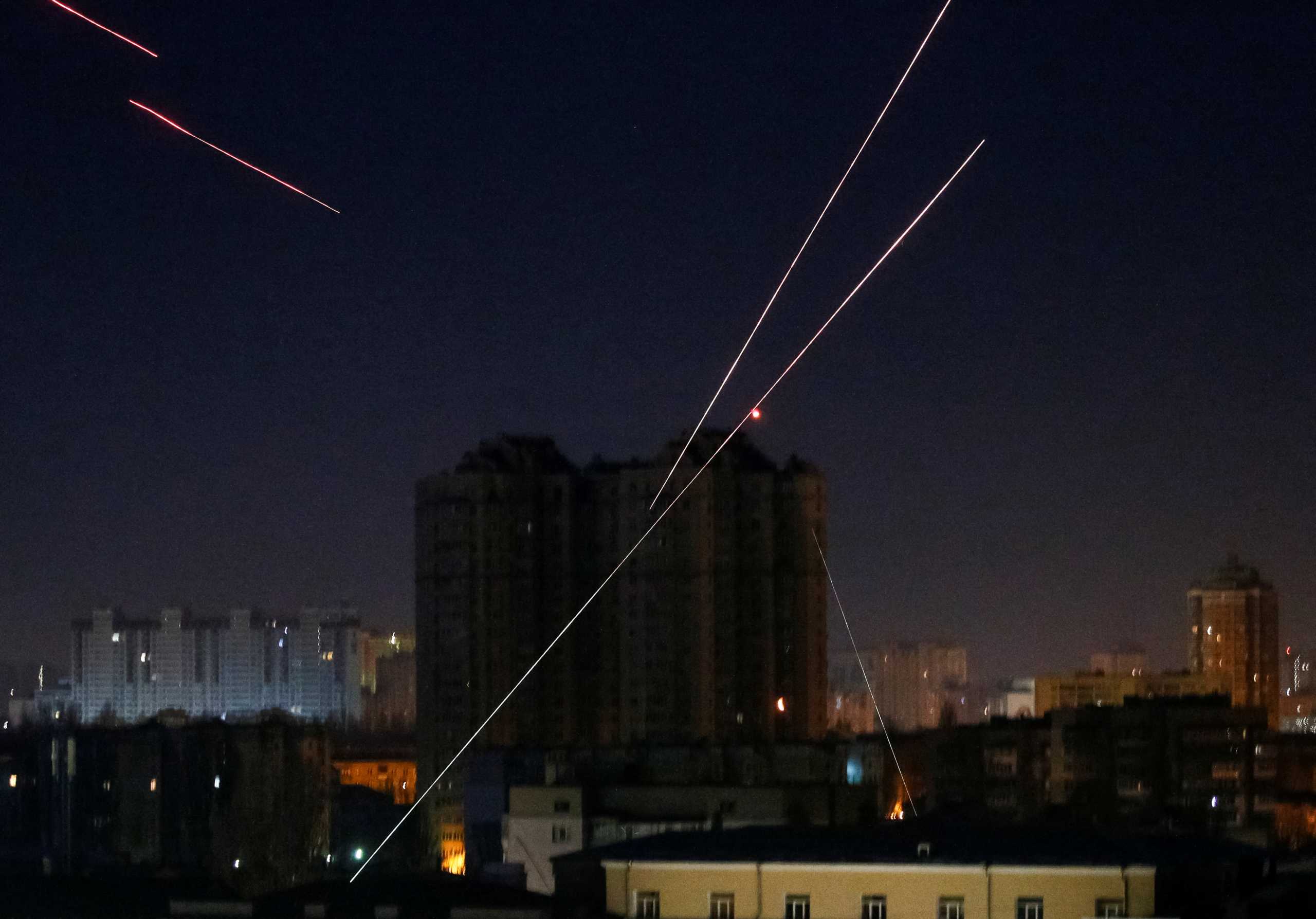 Tracers are seen in the night sky as Ukrainian servicemen fire on the drone as Russia's attack on Ukraine continues, in Kyiv, Ukraine March 14, 2022. REUTERS