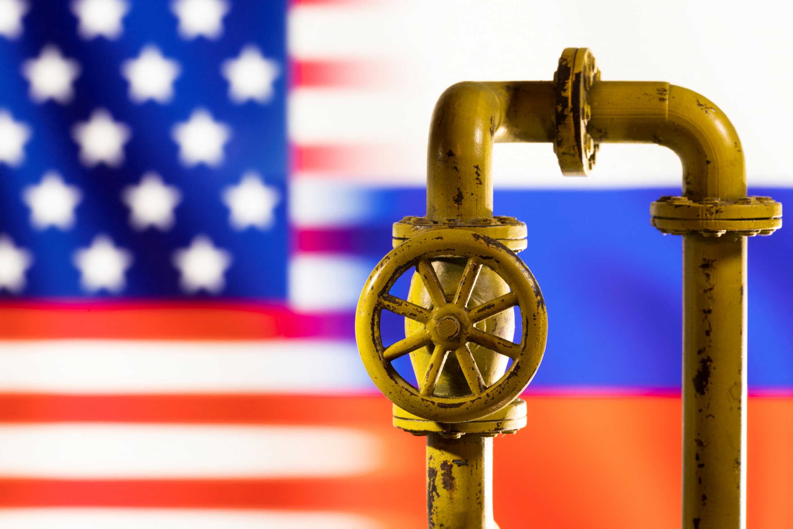 Models of natural gas pipeline is seen in front of displayed word U.S. and Russia flag colours in this illustration taken March 8, 2022. REUTERS