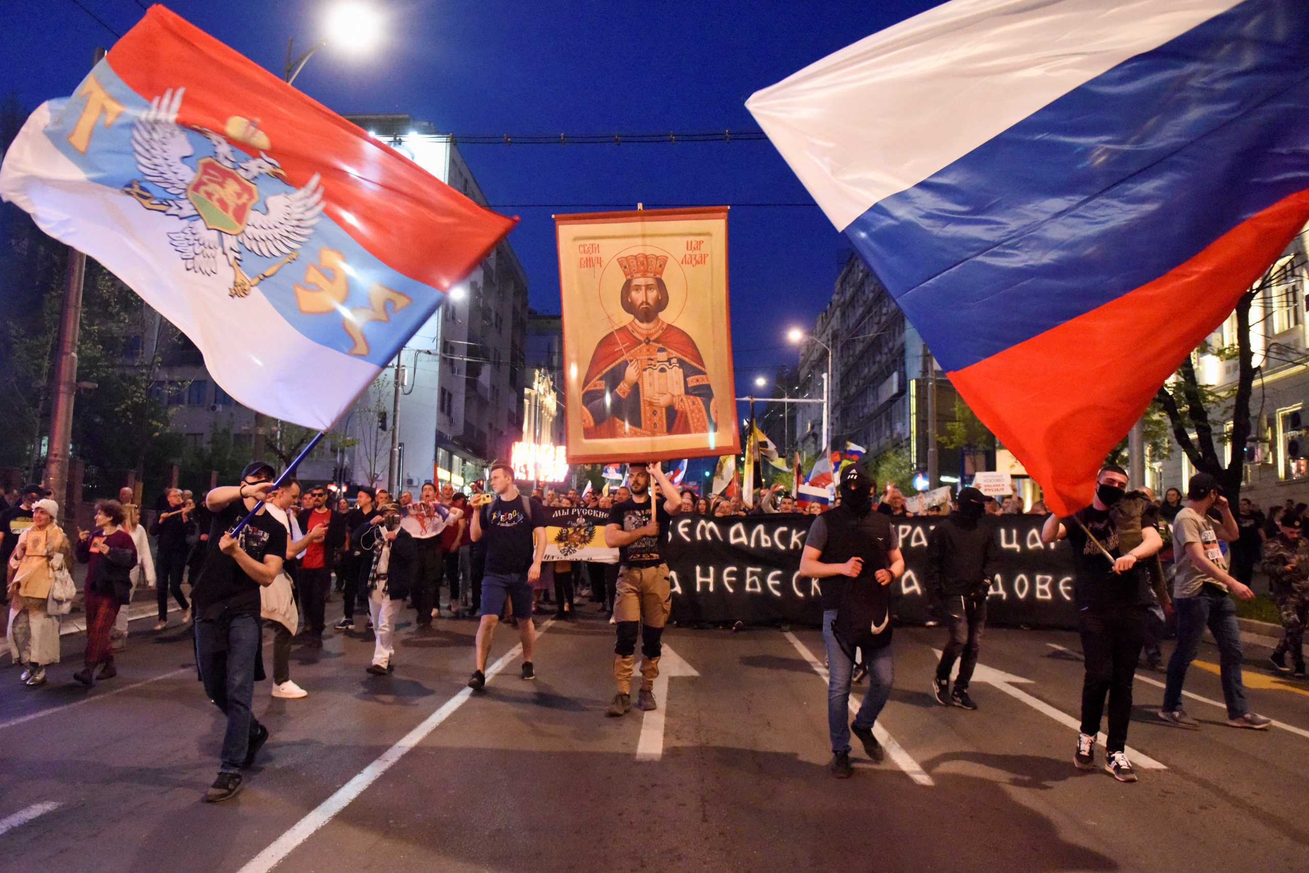 People wave Russian flags during a protest against the Serbian authorities for voting to suspend Russia's membership in the UN Human Rights Council in Belgrade, Serbia, April 15, 2022. REUTERS