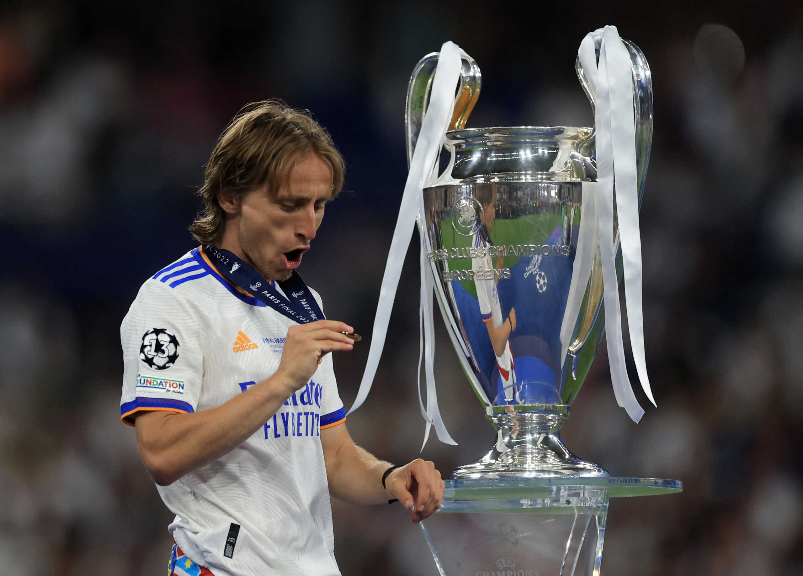 Soccer Football - Champions League Final - Liverpool v Real Madrid - Stade de France, Saint-Denis near Paris, France - May 28, 2022 Real Madrid's Luka Modric celebrates with the trophy and his medal after winning the Champions League REUTERS