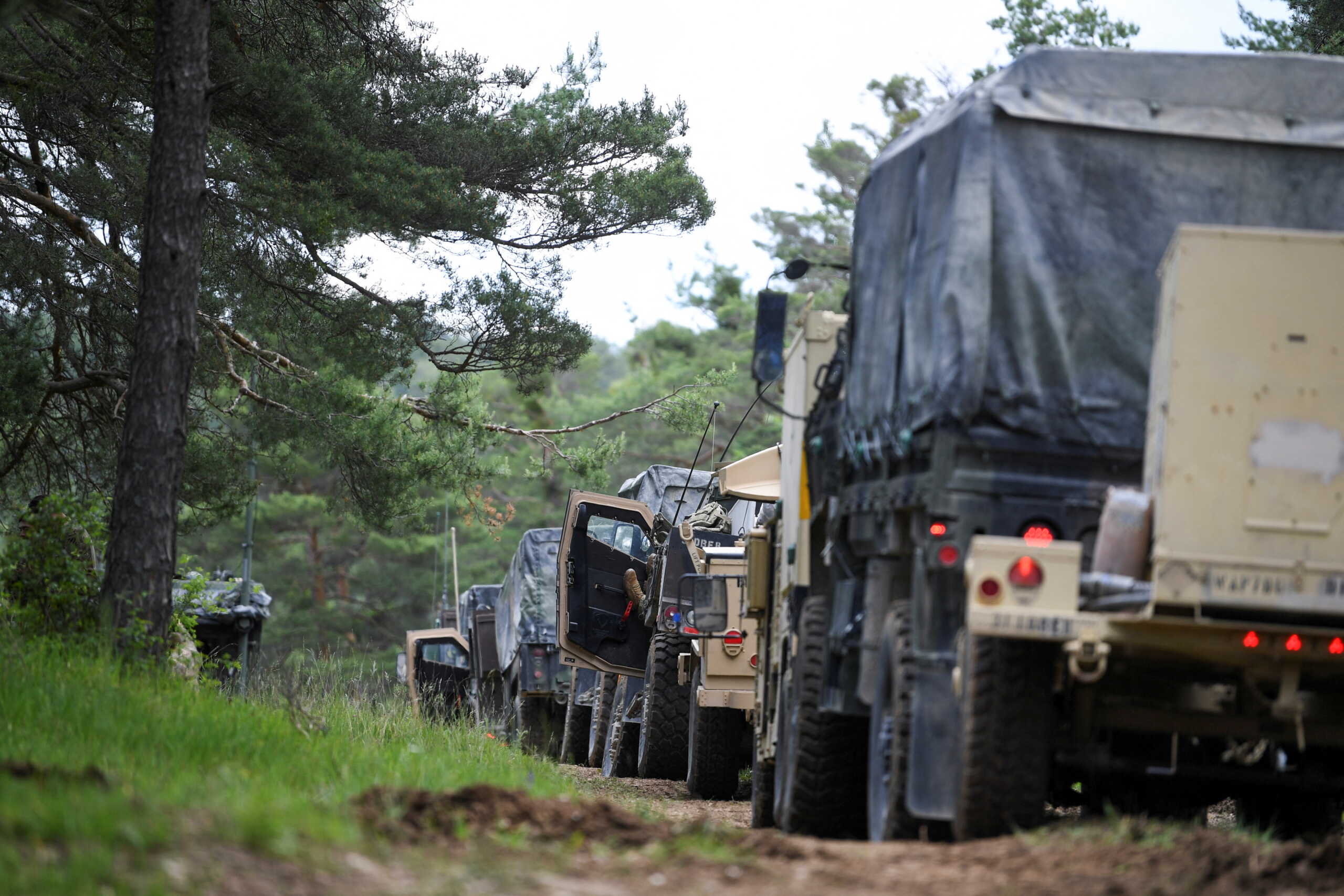 U.S. military vehicles are parked in a forest during a Combined Resolve military exercise at Joint Multinational Readiness Center (JMRC) Hohenfels, Germany, June 8, 2022. REUTERS