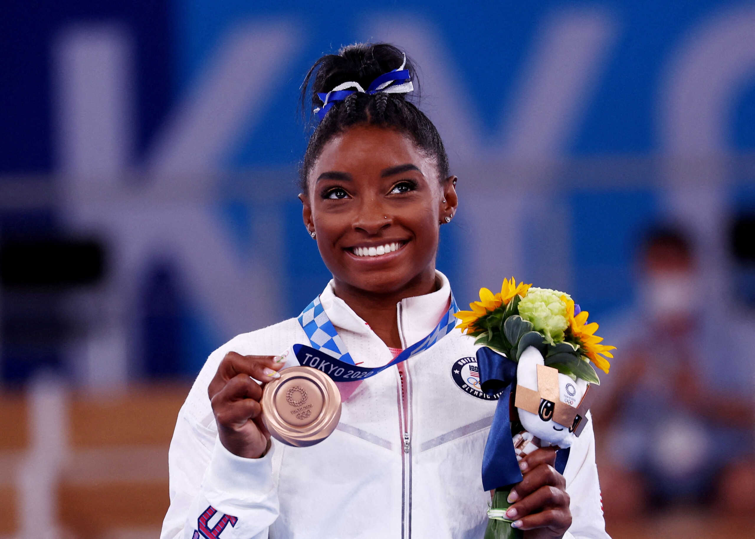 FILE PHOTO: Tokyo 2020 Olympics - Gymnastics - Artistic - Women's Beam - Medal Ceremony - Ariake Gymnastics Centre, Tokyo, Japan - August 3, 2021. Bronze medallist Simone Biles of the United States celebrates on the podium REUTERS