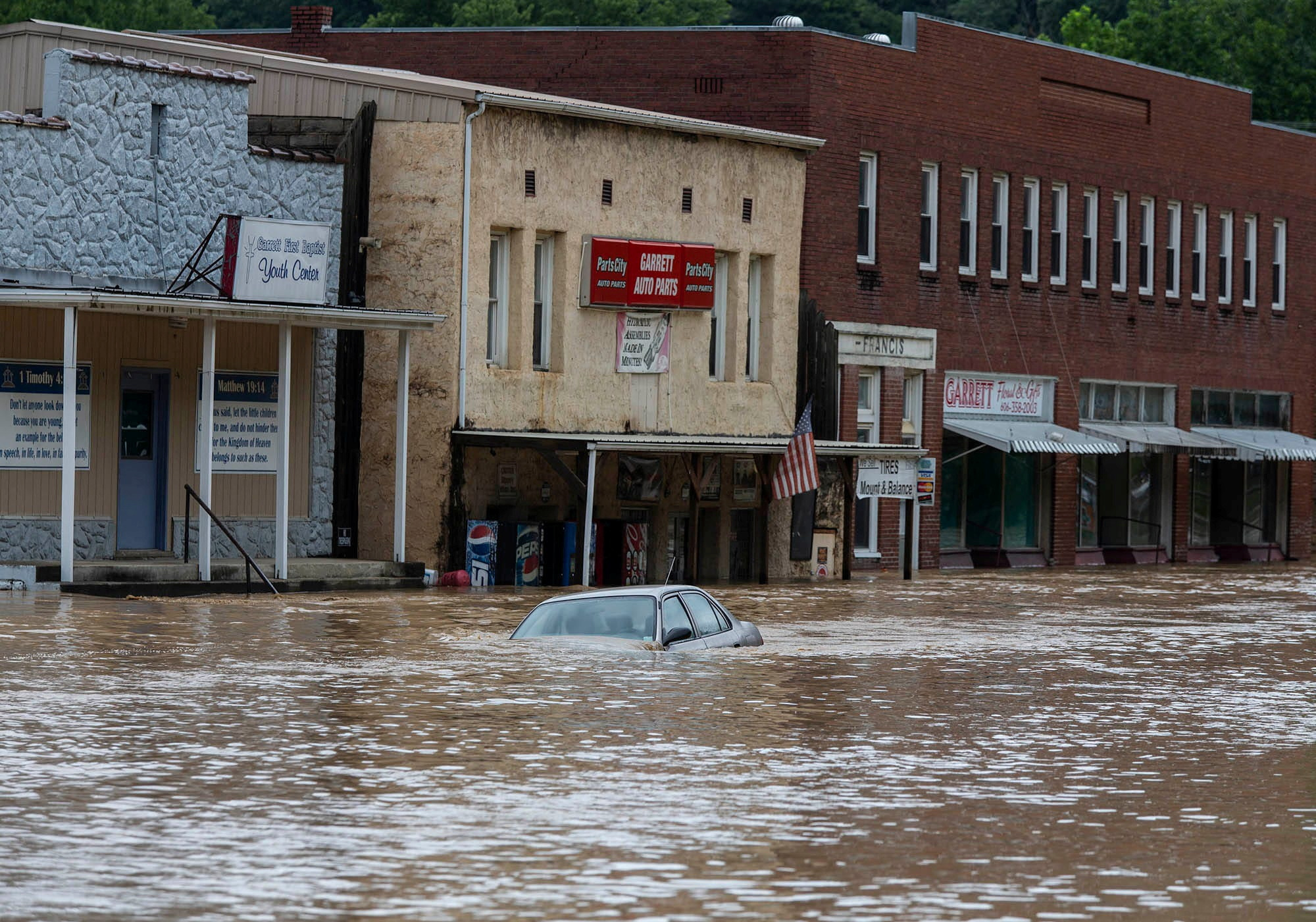 A car is submerged in flood waters along Right Beaver Creek, following a day of heavy rain in in Garrett, Kentucky, U.S. July 28, 2022.  Pat McDonogh