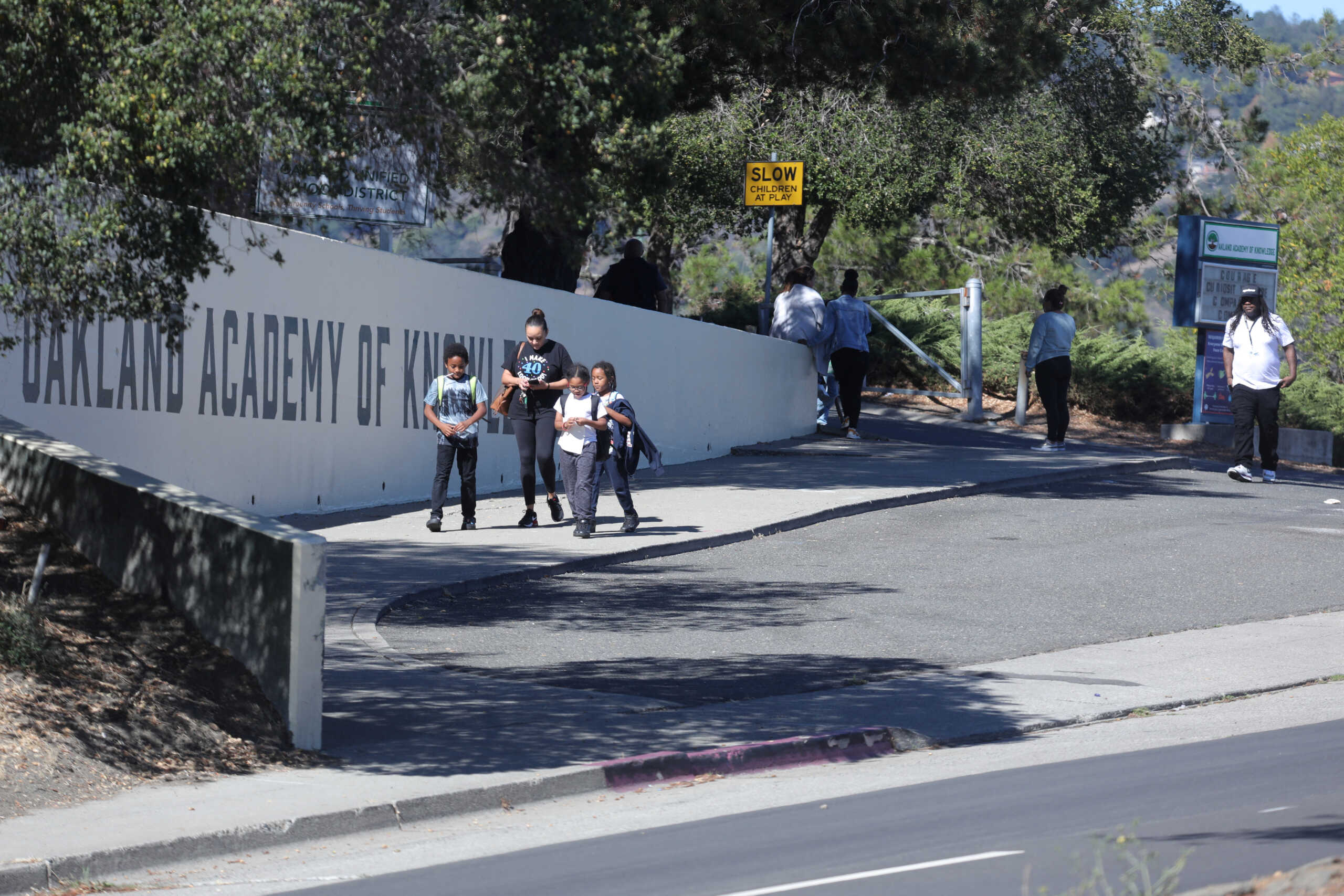 Parents pick up their children at the Oakland Academy of Knowledge after a shooting nearby in Oakland, California, U.S. September 28, 2022. REUTERS