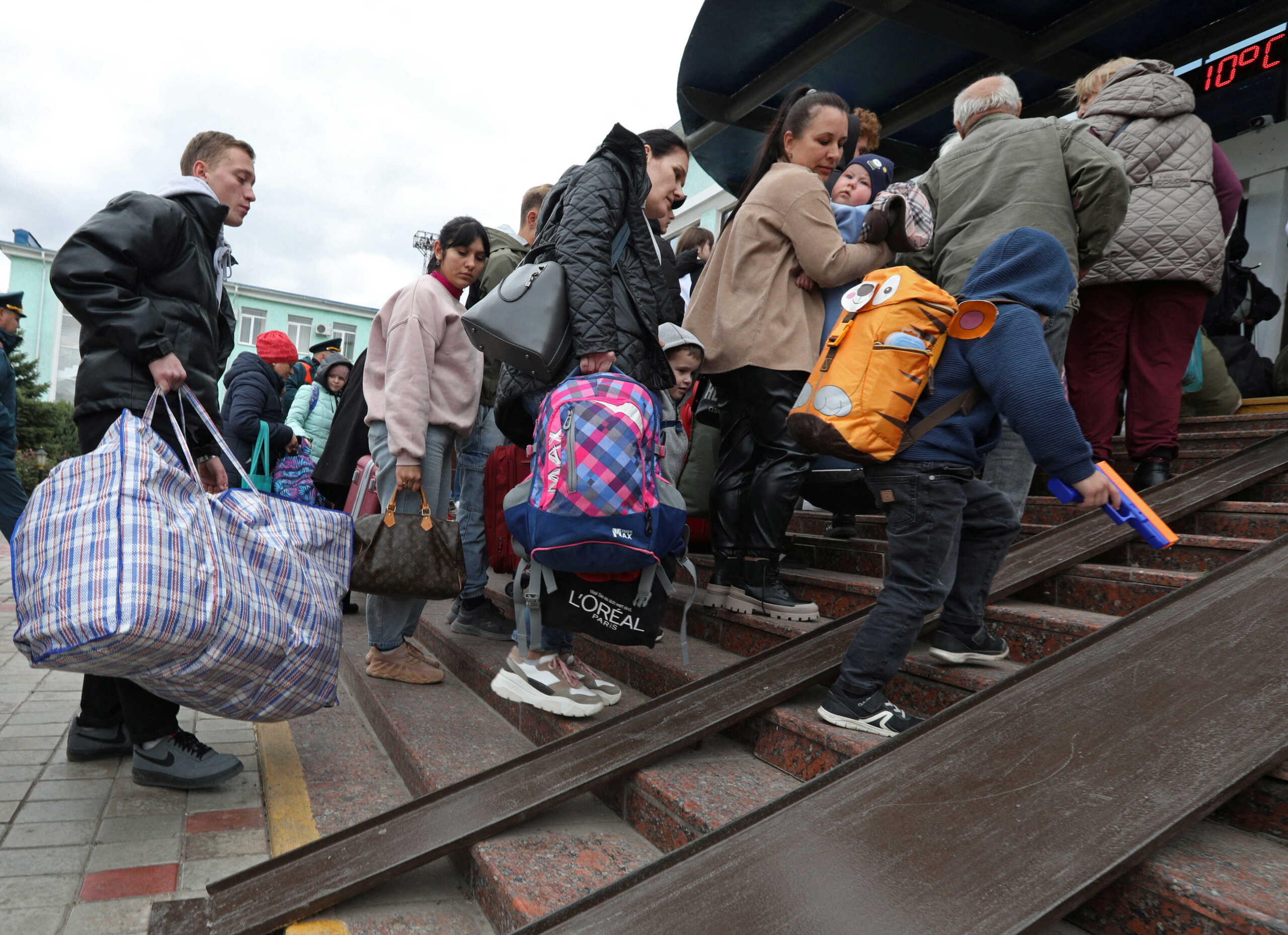 Civilians evacuated from the Russian-controlled Kherson region of Ukraine arrive at a railway station in the town of Dzhankoi, Crimea October 20, 2022. REUTERS