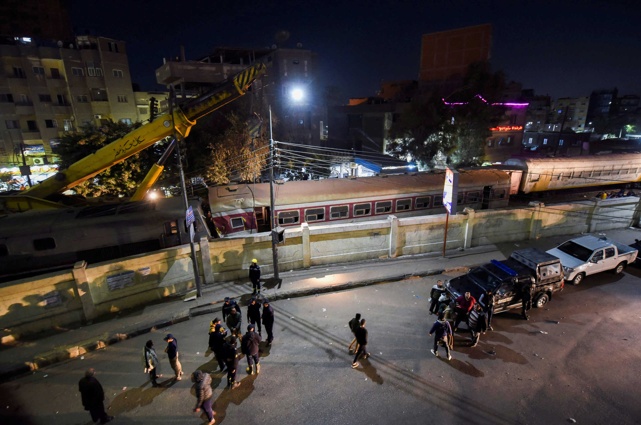 People gather on a bridge above the scene of a train crash in the city of Qalyub in Al Qalyubia Governorate, north of Cairo, Egypt, March 7, 2023. REUTERS