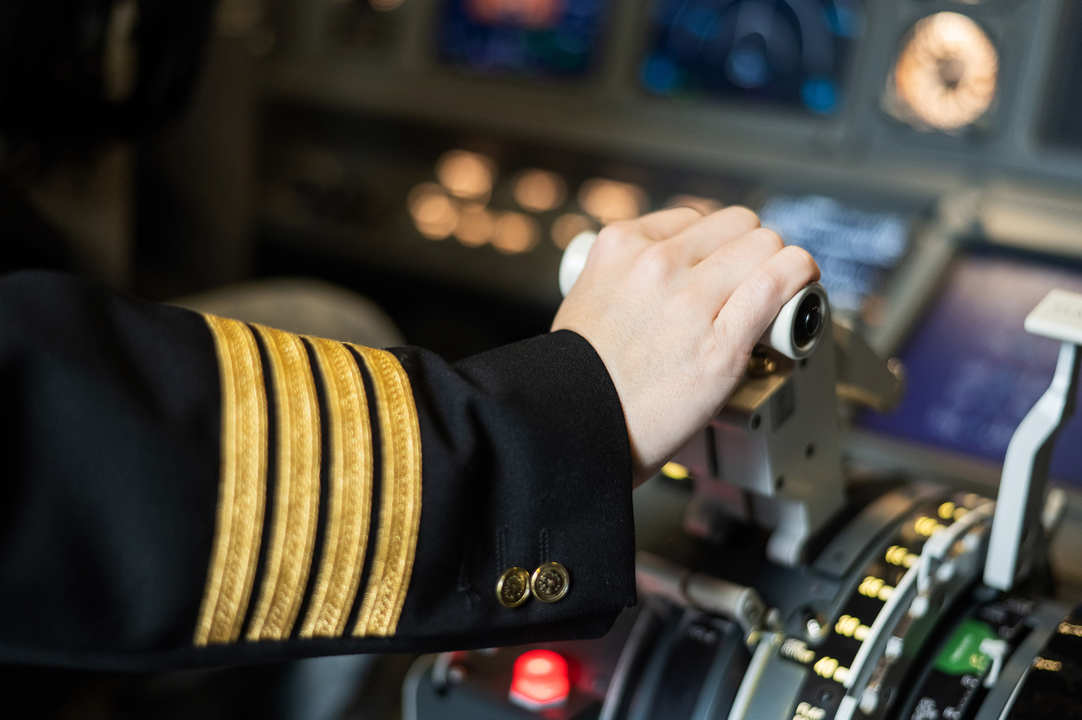 Female pilot's hand on the plane engine control stick