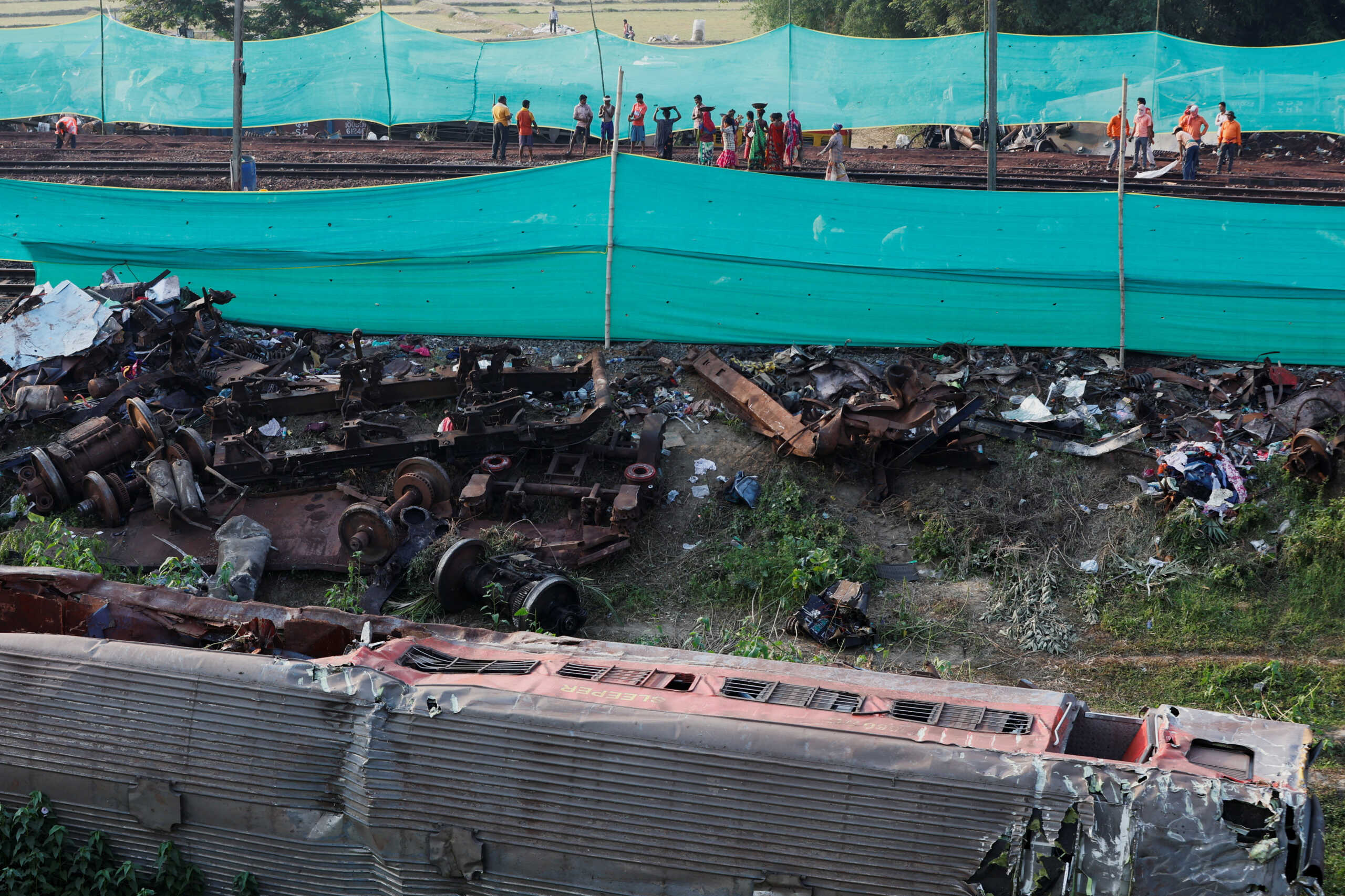 Workers repair the rail track at the site of a train collision following the accident in Balasore district in the eastern state of Odisha, India, June 5, 2023. REUTERS