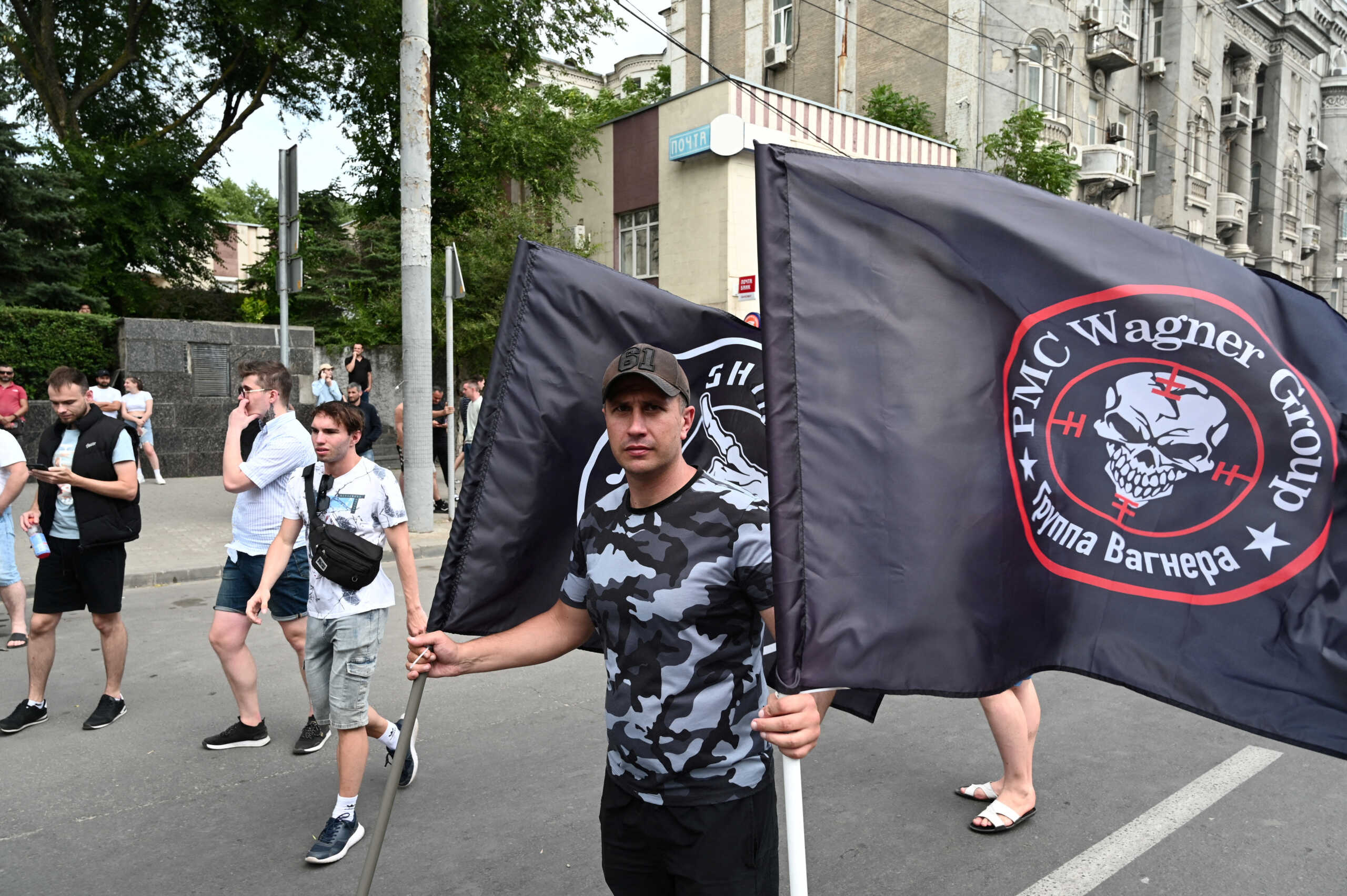 FILE PHOTO: A supporter of Wagner private mercenary group holds flags near the headquarters of the Southern Military District controlled by Wagner fighters in the city of Rostov-on-Don, Russia, June 24, 2023. REUTERS