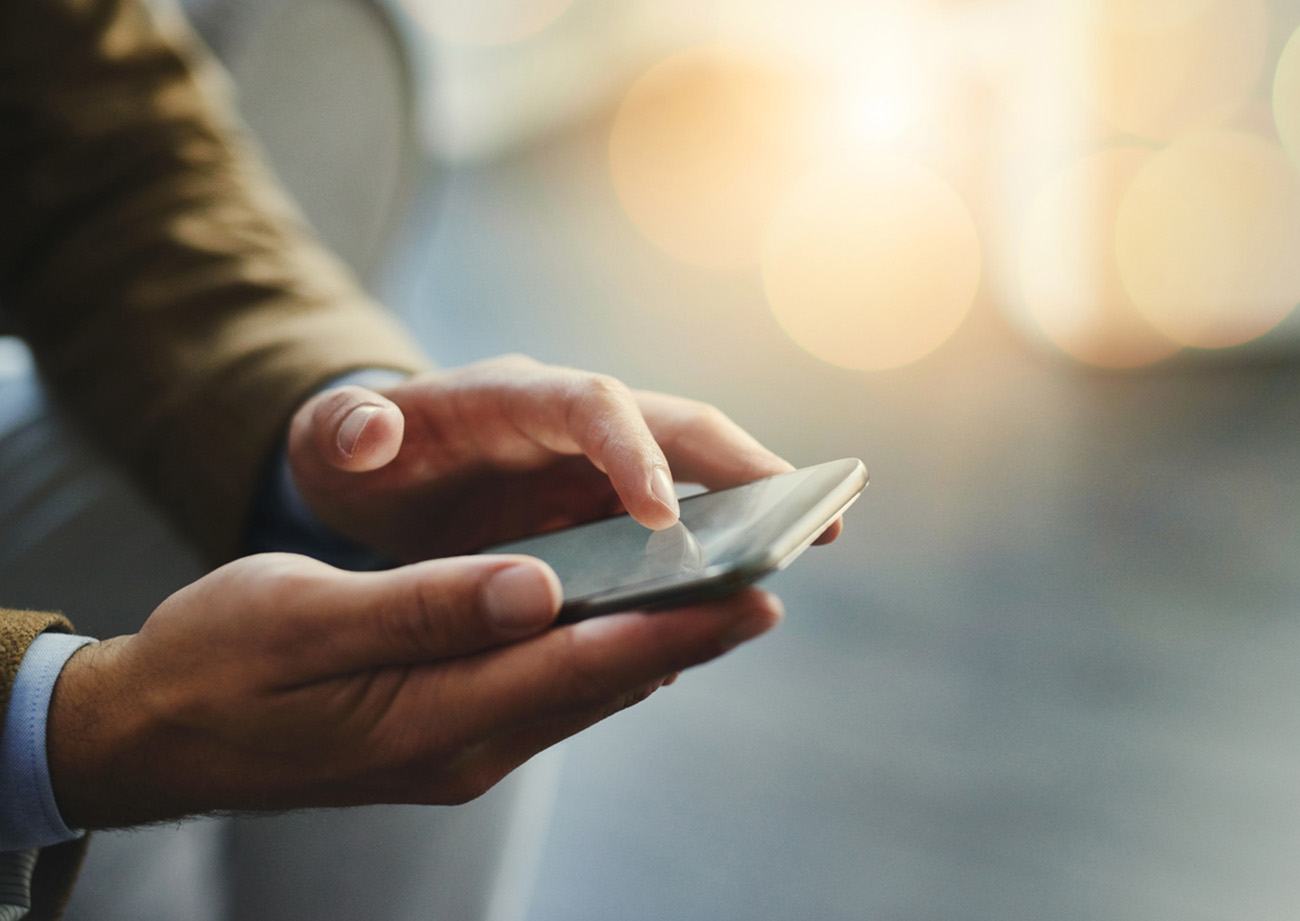 High angle shot of an unrecognizable businessman using a mobile phone