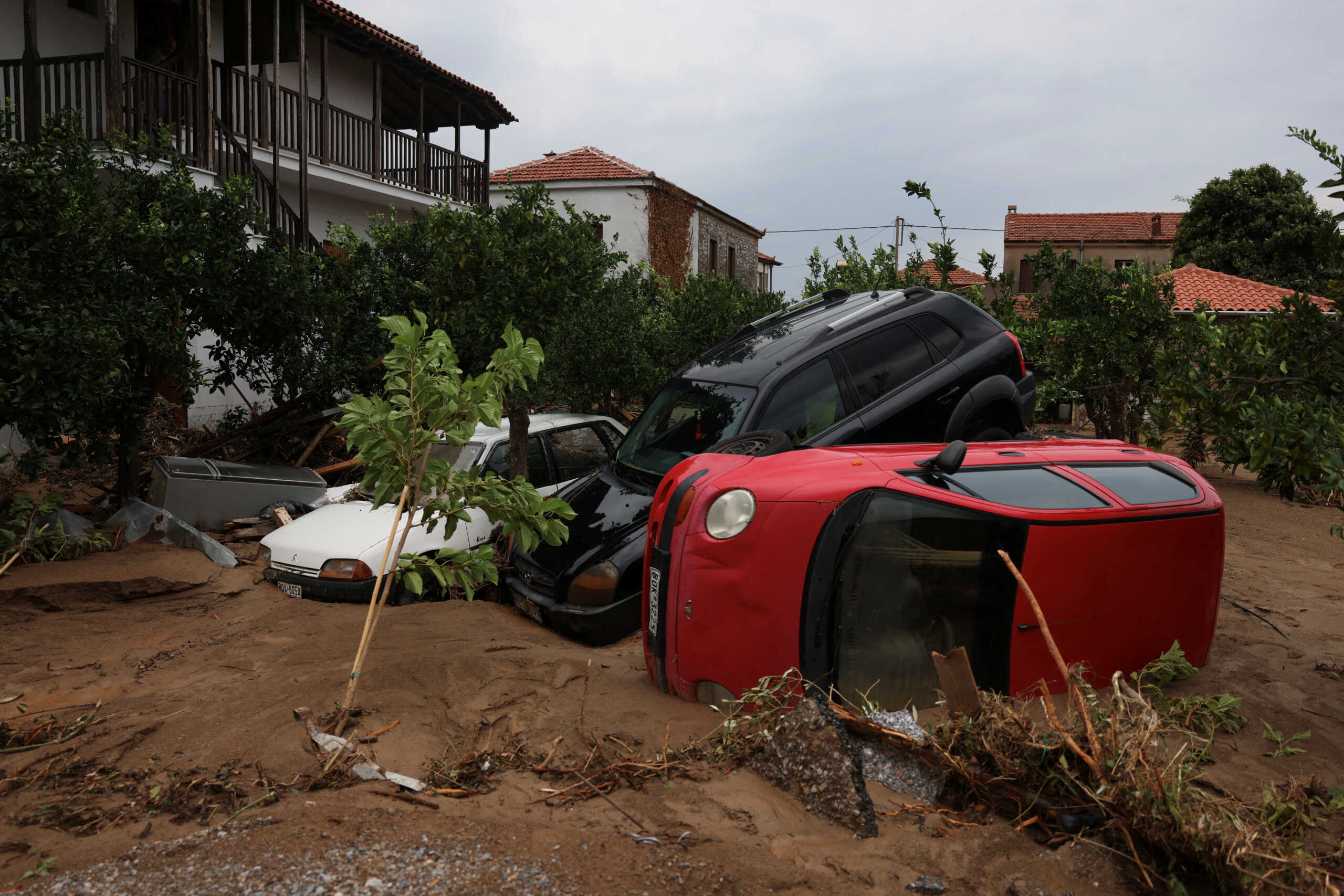 Damaged cars are seen on a muddy road, as storm Daniel hits central Greece, in the village of Milina, Greece, September 6, 2023. REUTERS