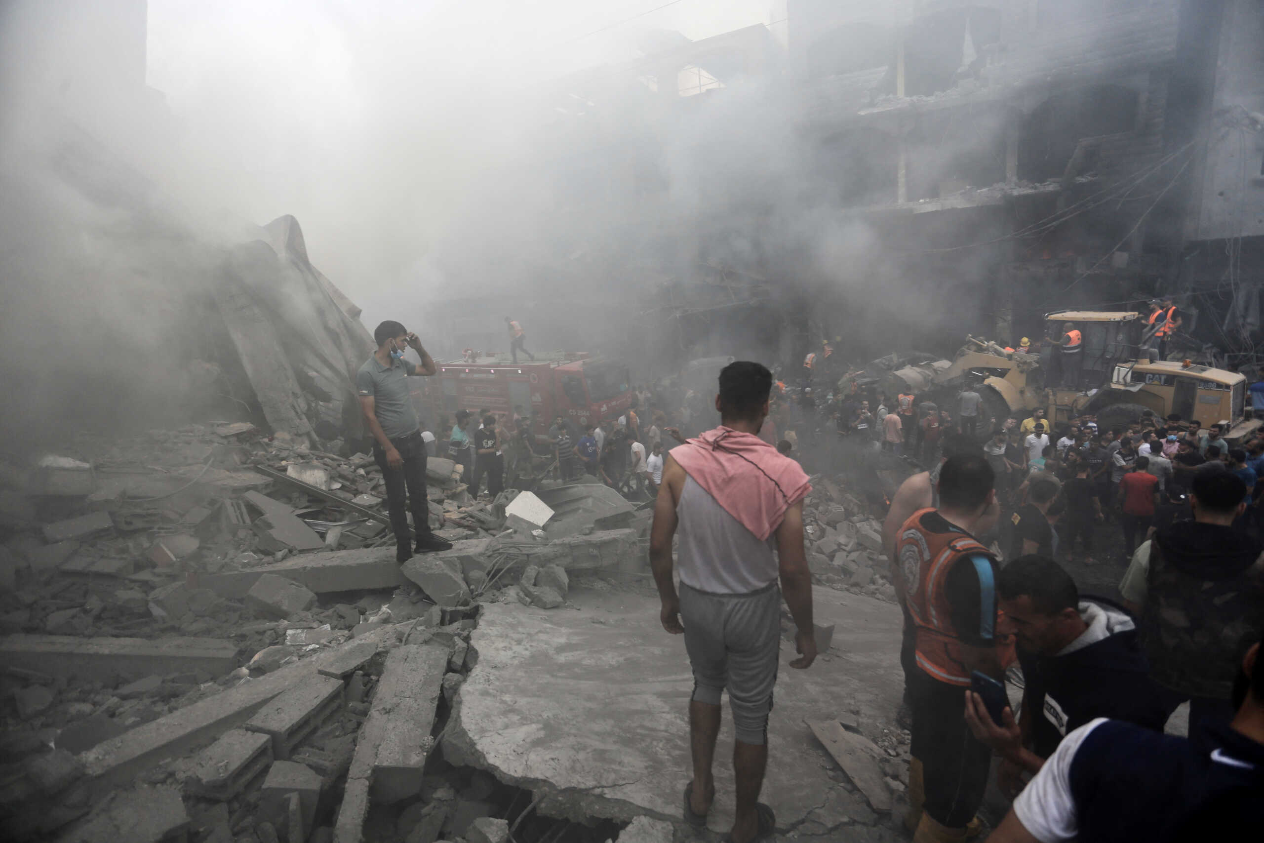 Palestinians gather at the site of Israeli strikes, in Jabalia refugee camp, in the northern Gaza Strip October 9, 2023. REUTERS