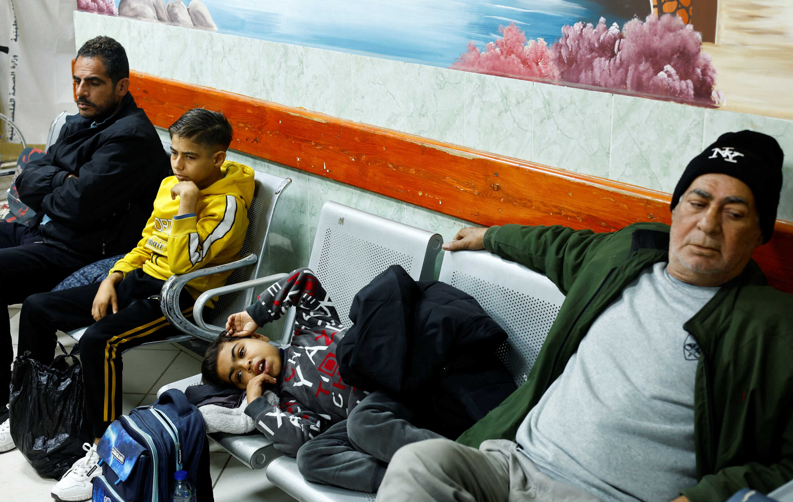 Palestinian boy Naseem Mohra, a 10-year-old kidney patient from northern Gaza who fled south with his family when Israel began the ground assault against Hamas and was separated from his mother, waits to undergo kidney dialysis