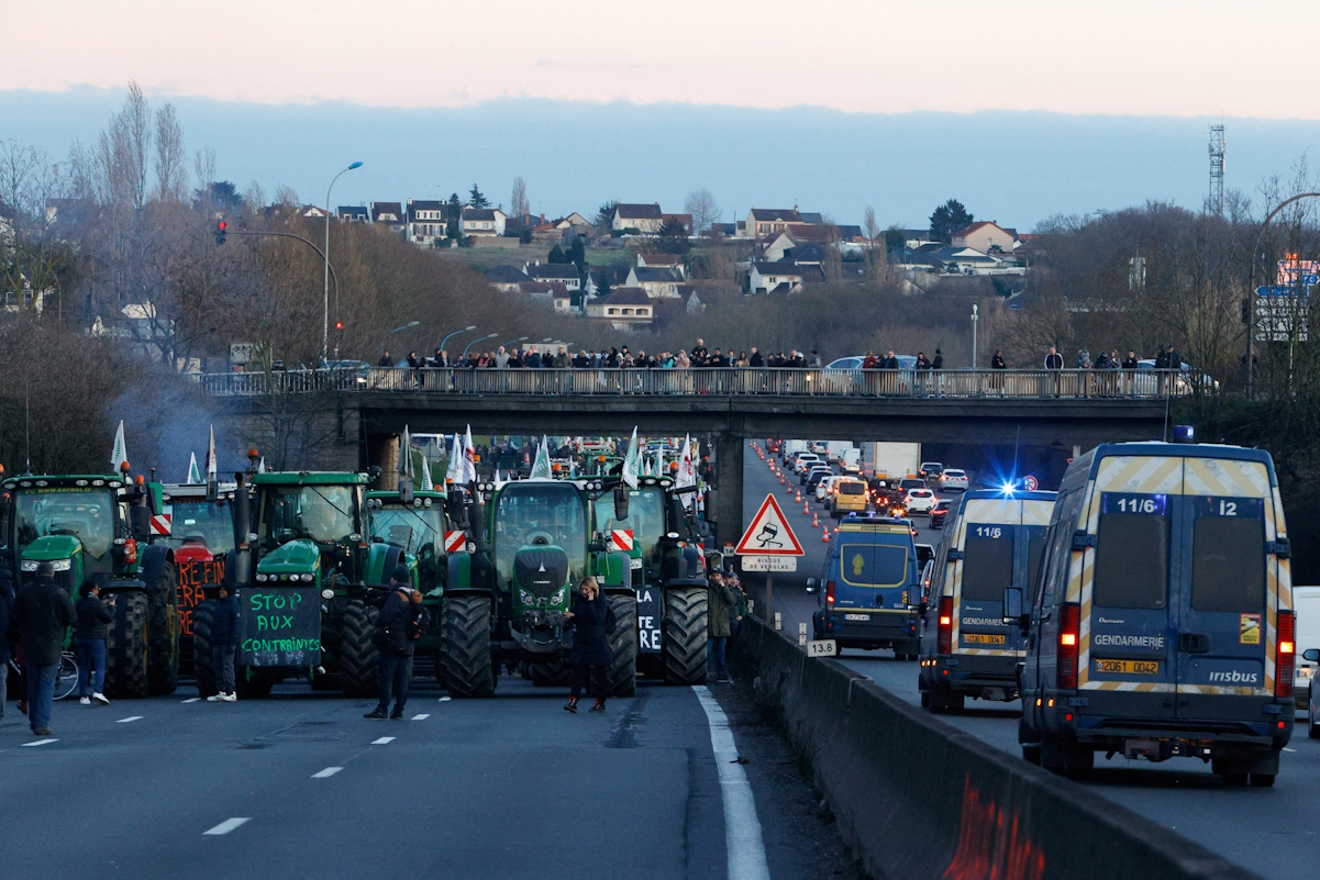 People gather during a farmer's protest over price pressures, taxes and green regulation, grievances shared by farmers across Europe, near Chilly-Mazarin, near Paris, France, January 31, 2024. REUTERS