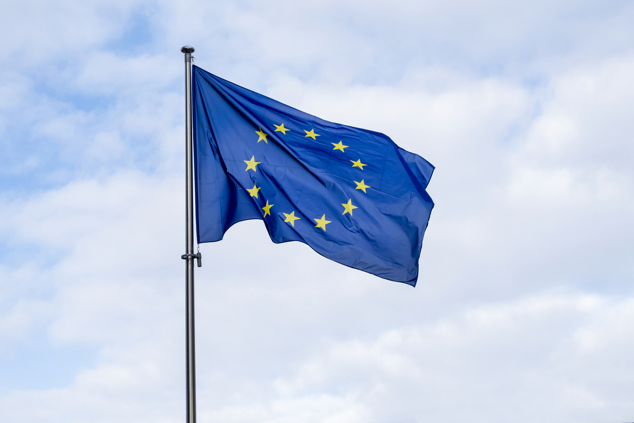 Panoramic view of a waving EU flag or European Union flag against blue sky