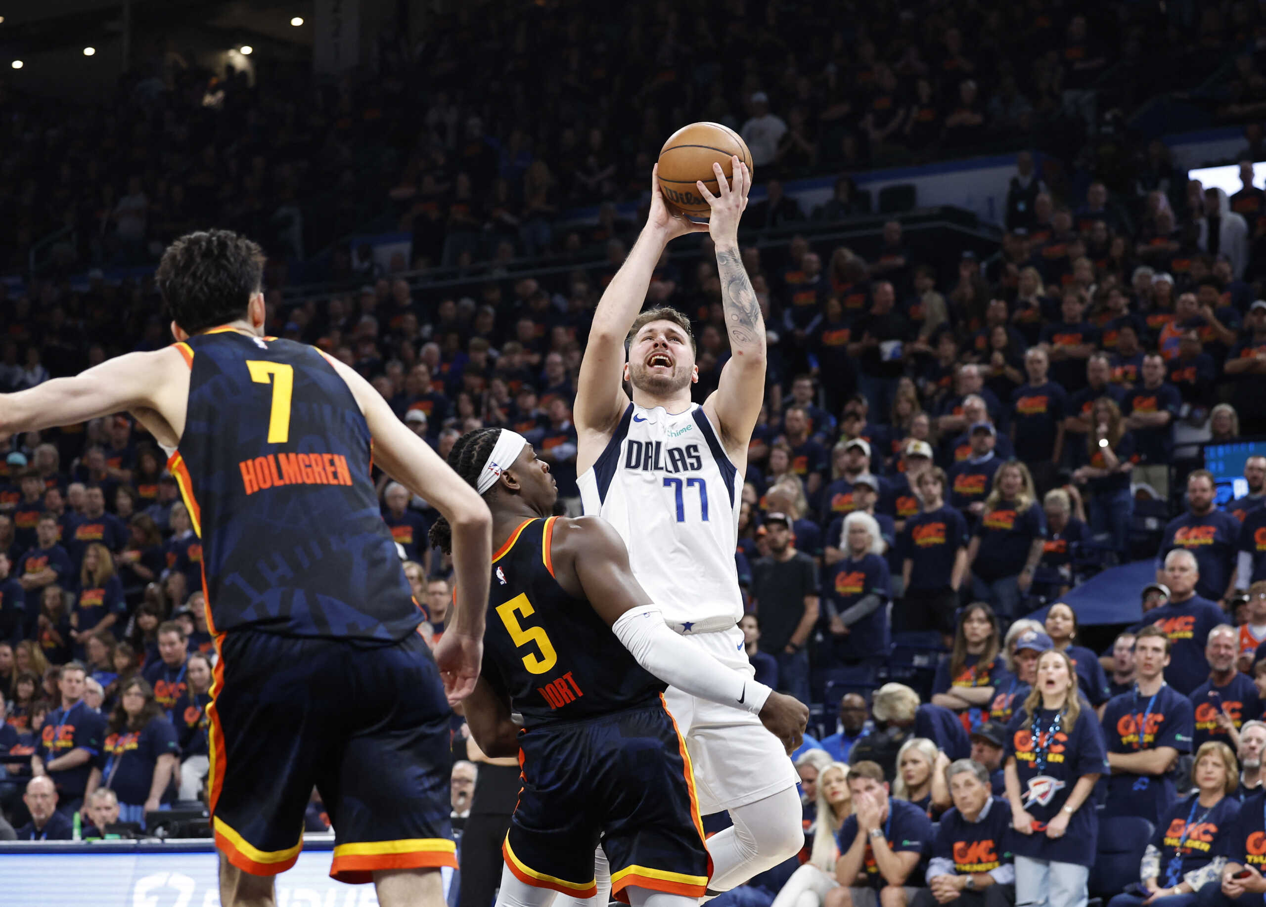 May 15, 2024; Oklahoma City, Oklahoma, USA; Dallas Mavericks guard Luka Doncic (77) shoots against Oklahoma City Thunder guard Luguentz Dort (5) during the second half of game five of the second round for the 2024 NBA playoffs at Paycom Center. Mandatory Credit: Alonzo Adams-USA TODAY Sports