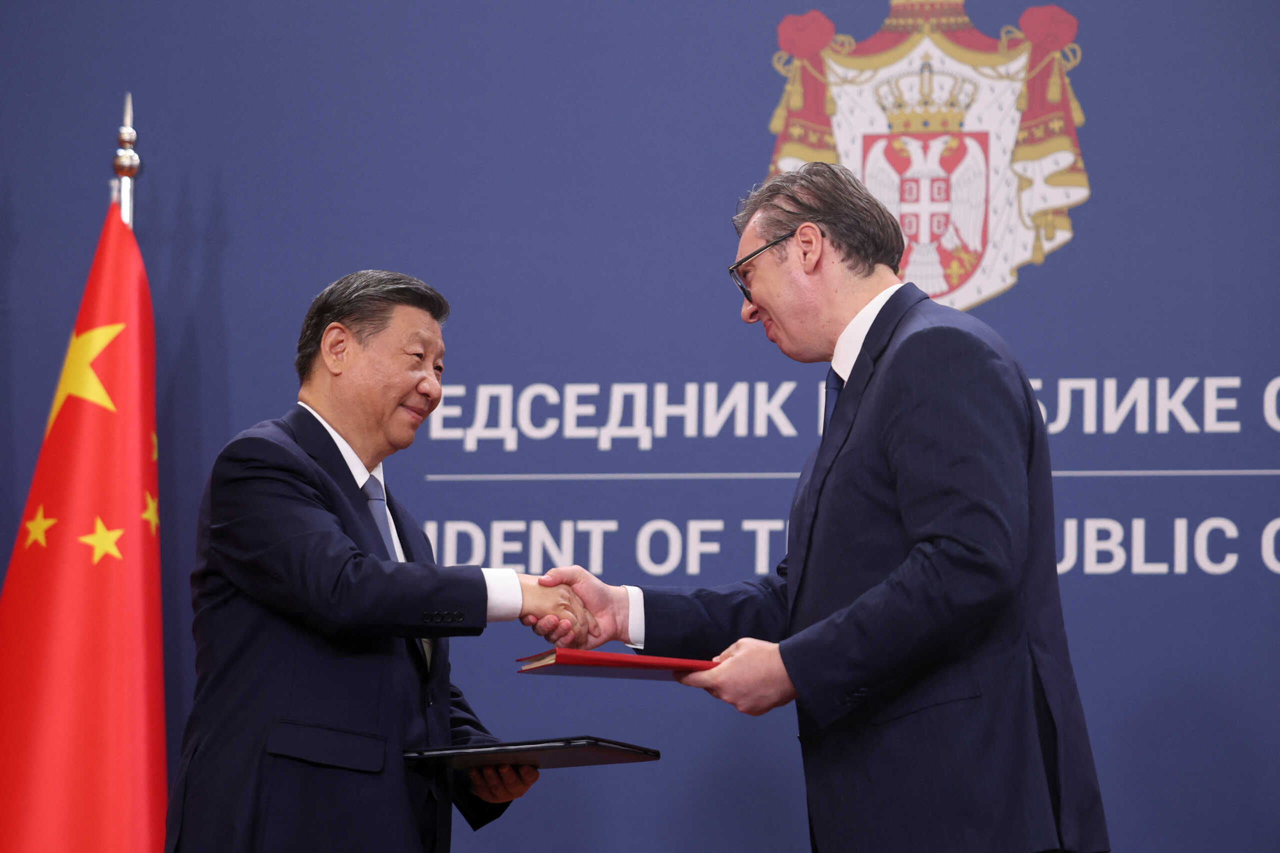 Chinese President Xi Jinping and Serbian President Aleksandar Vucic shake hands during a document signing at the Palace of Serbia during the Chinese president's two-day state visit in Belgrade, Serbia, May 8, 2024. REUTERS