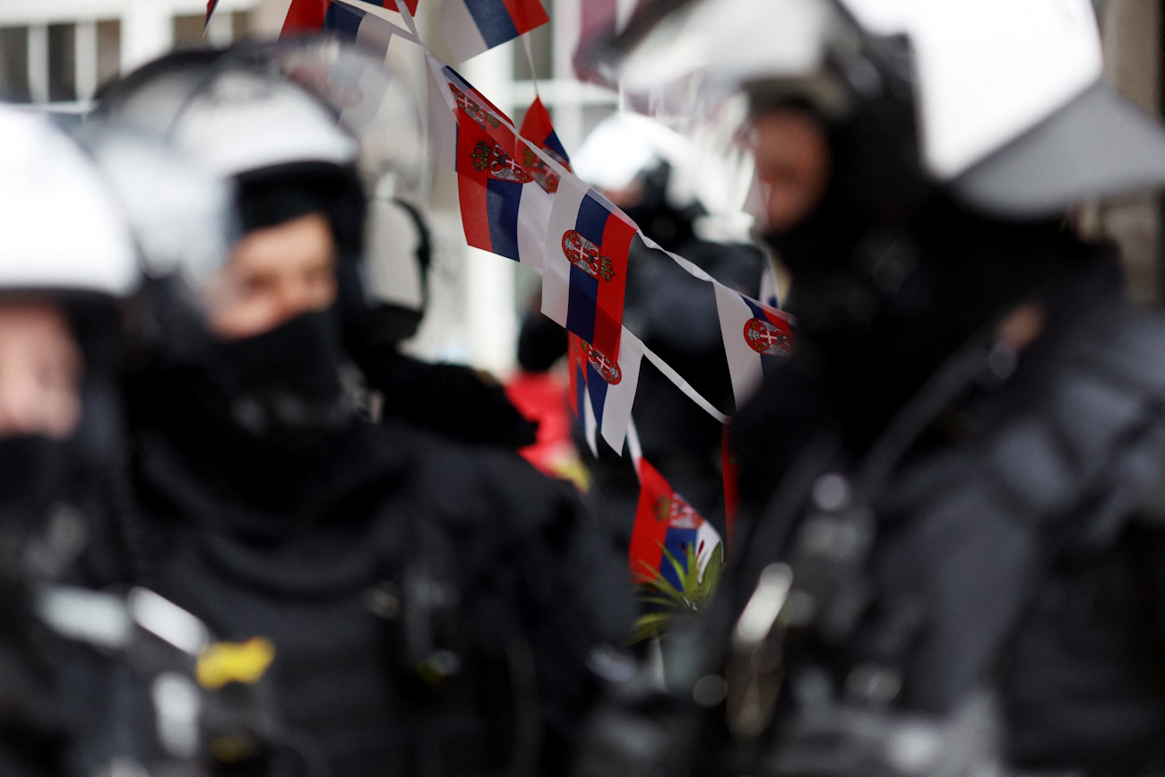 Soccer Football - Euro 2024 - Fans gather before Serbia v England - Gelsenkirchen, Germany - June 16, 2024 A general view of Serbia flags ahead of the match as police officers patrol the street REUTERS