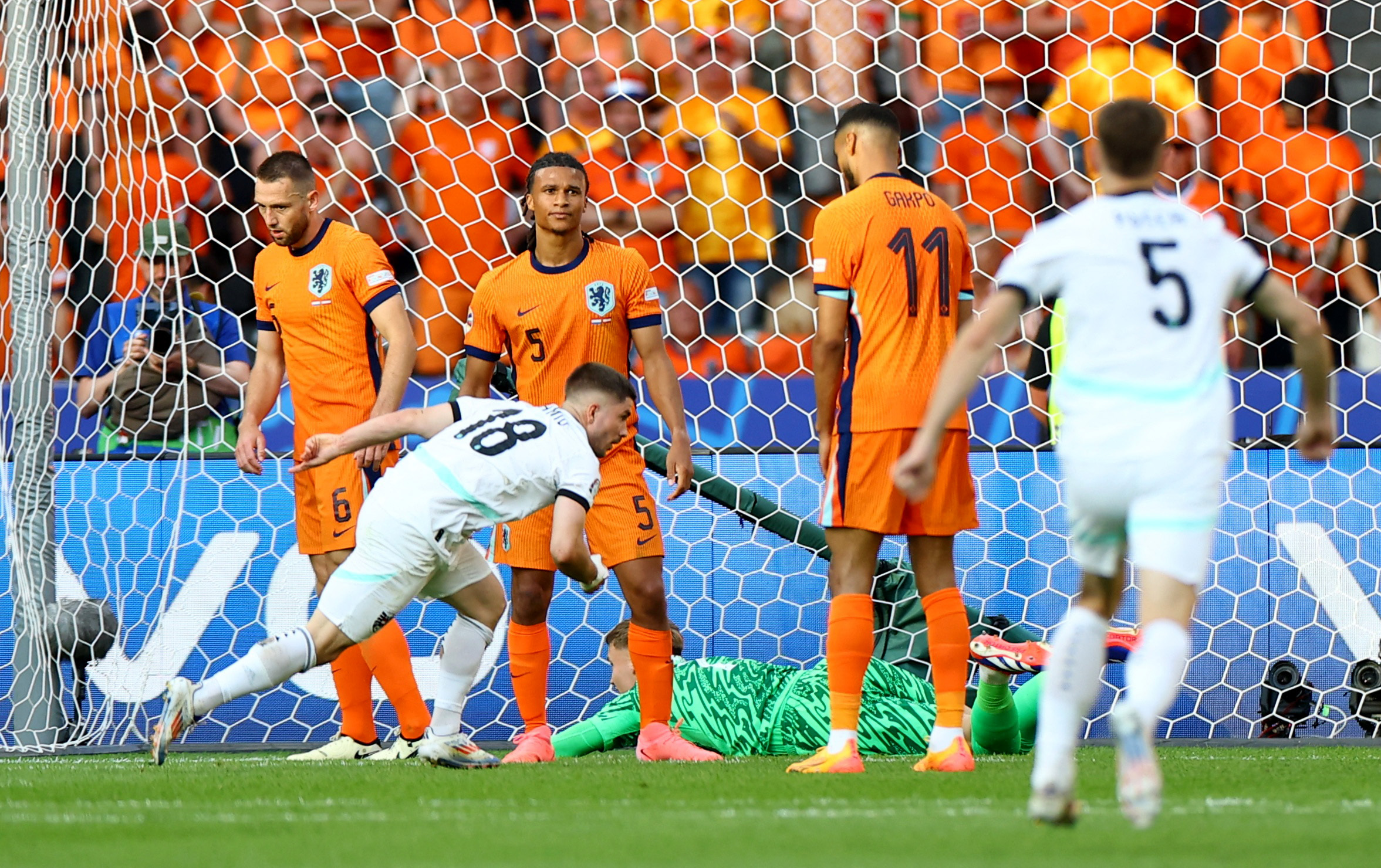 Soccer Football - Euro 2024 - Group D - Netherlands v Austria - Berlin Olympiastadion, Berlin, Germany - June 25, 2024 Austria's Romano Schmid celebrates scoring their second goal as Netherlands' Nathan Ake looks dejected REUTERS