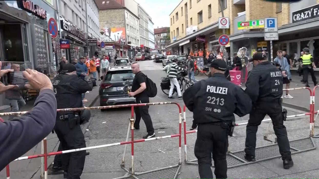 Screen grab of moment a man carrying an axe was shot down by police officers in the St. Pauli district of Hamburg, before Euro 2024 match between Poland v Netherlands in Hamburg, Germany. June 16, 2024 Nonstopnews