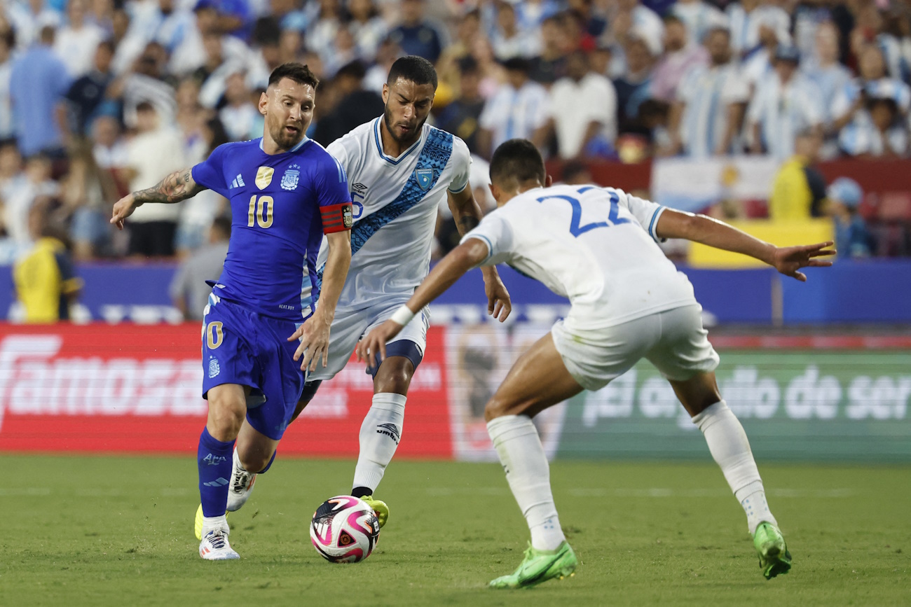 Jun 14, 2024; Landover, Maryland, USA; Argentina forward Lionel Messi (10) dribbles the ball as Guatemala midfielder Marco Dominguez (5) and Guatemala midfielder Jonathan Franco (22) defend in the first half at Commanders Field. Mandatory Credit: Geoff Burke-USA TODAY Sports