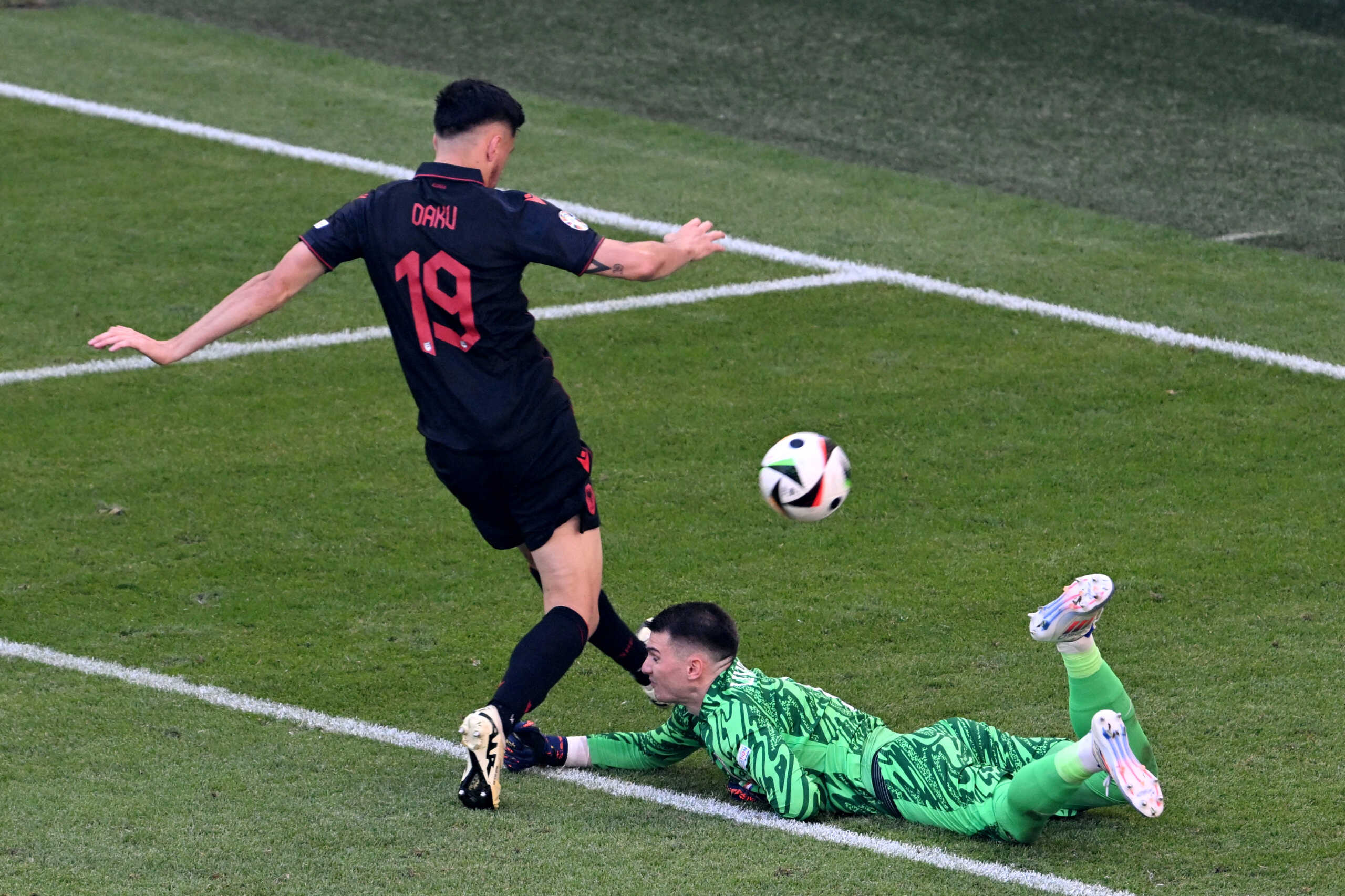 Soccer Football - Euro 2024 - Group B - Croatia v Albania - Hamburg Volksparkstadion, Hamburg, Germany - June 19, 2024 Croatia's Dominik Livakovic in action with Albania's Mirlind Daku REUTERS