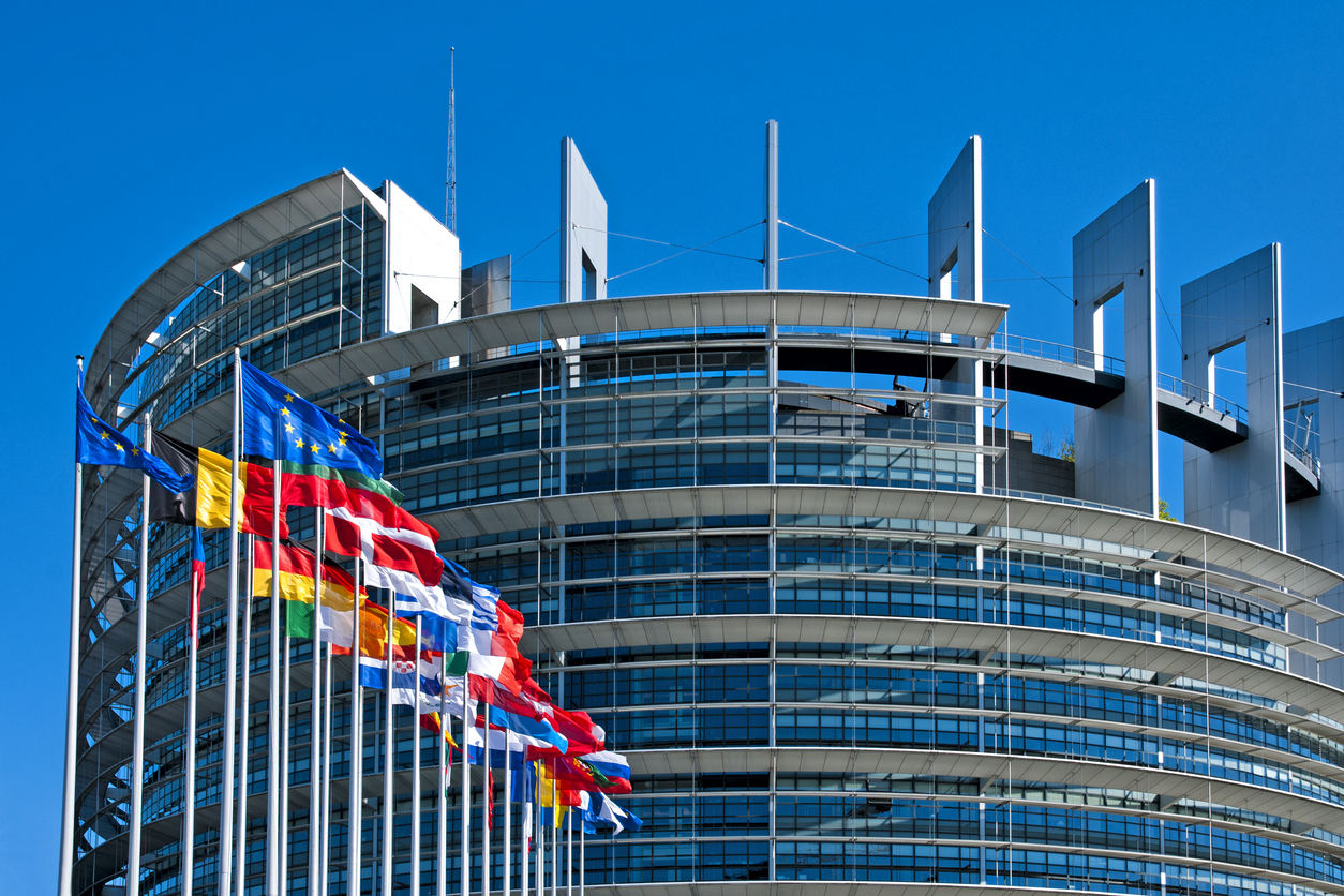 The European Parliament building in Strasbourg, France with flags waving calmly celebrating peace of the Europe. July 12, 2020.